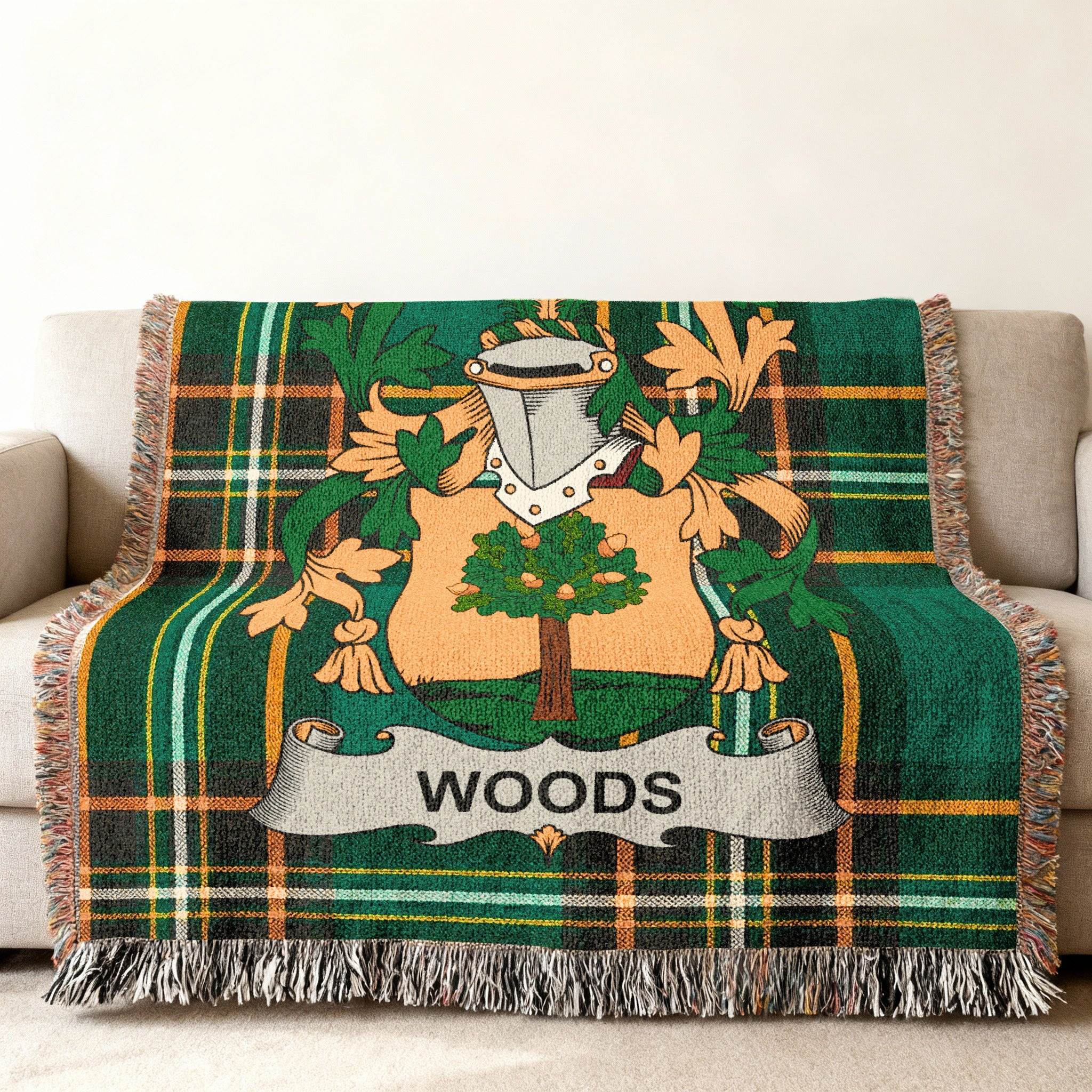 Green plaid woven throw blanket featuring a coat of arms with the name WOODS.