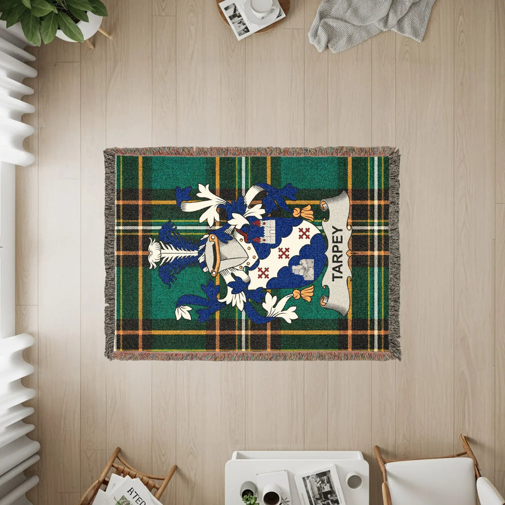 Tapestry featuring the Tarpey family crest on a green tartan background.