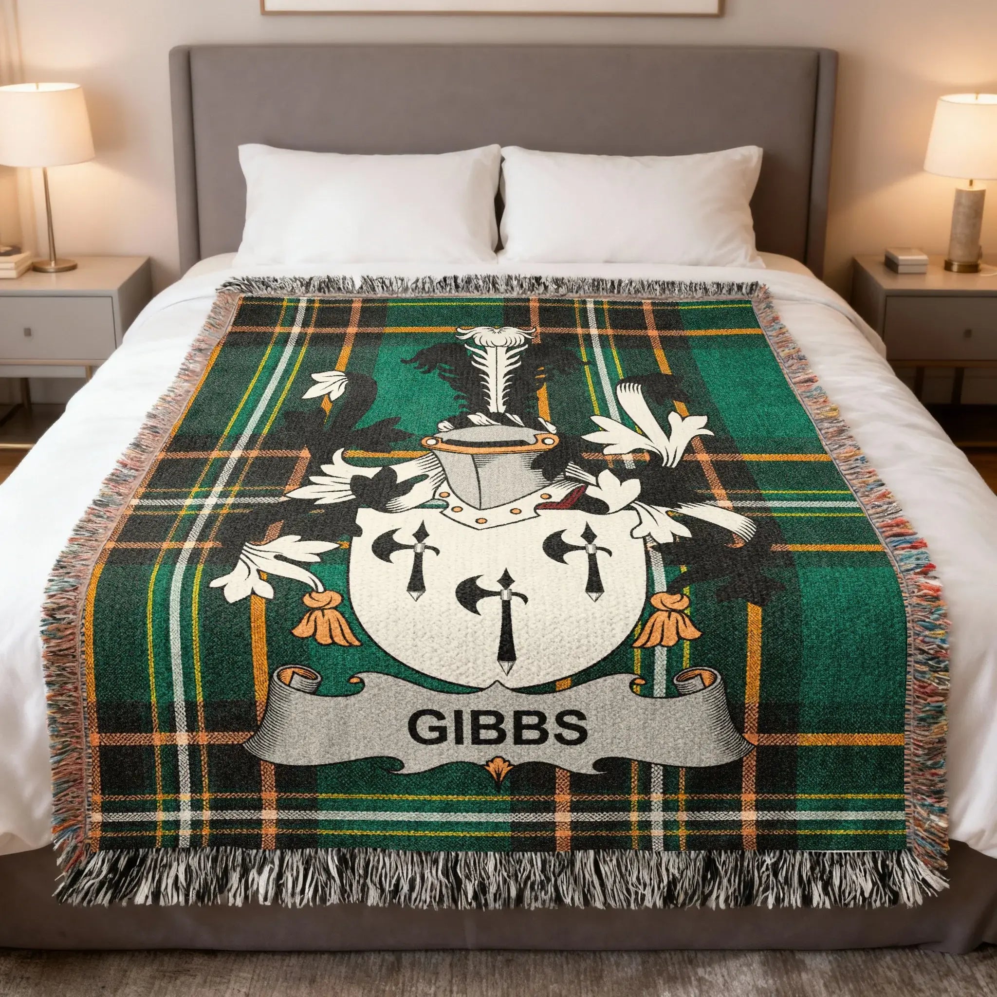 Plaid throw blanket with Gibbs family crest on a bed.