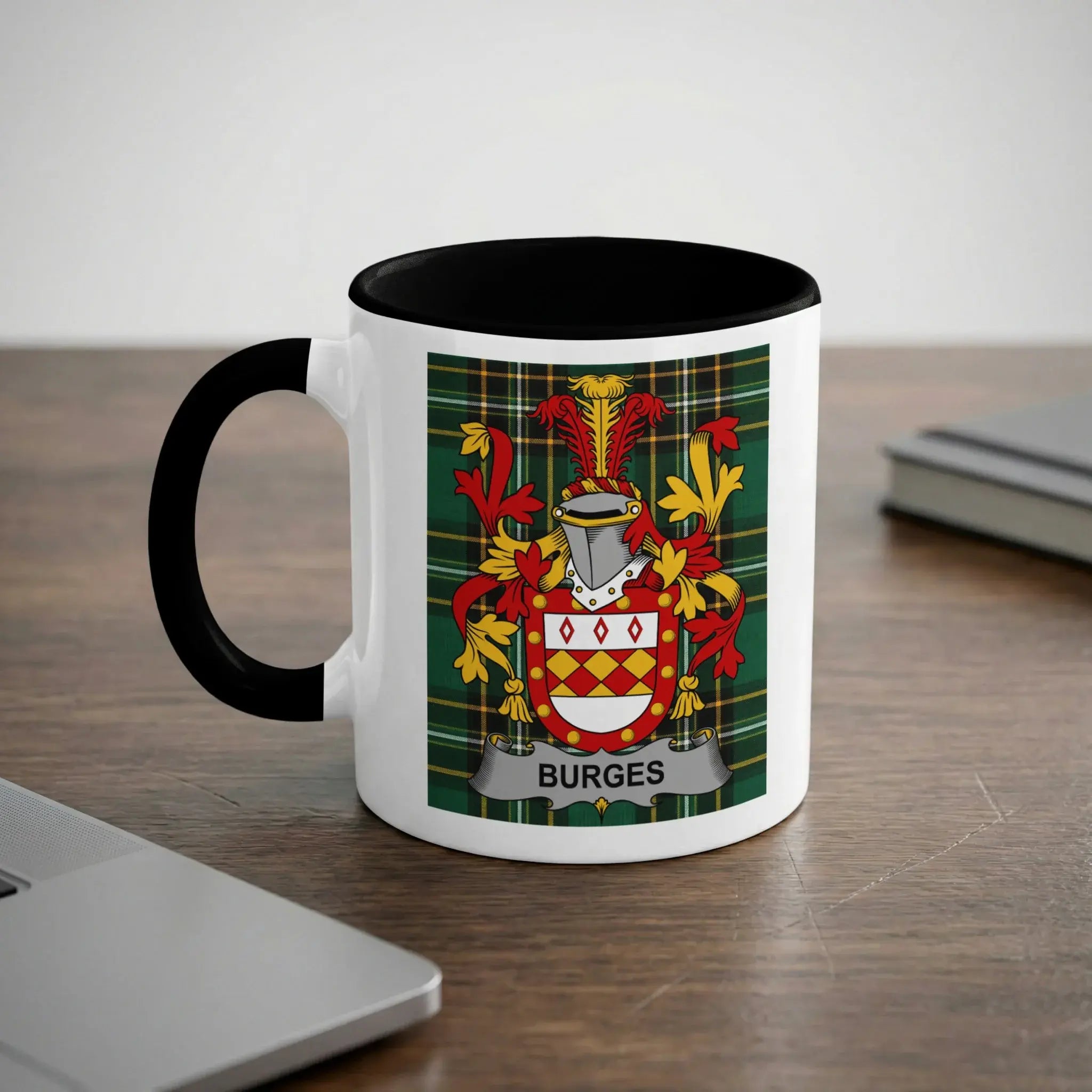 White mug with black handle featuring the Burges family crest on a plaid background.