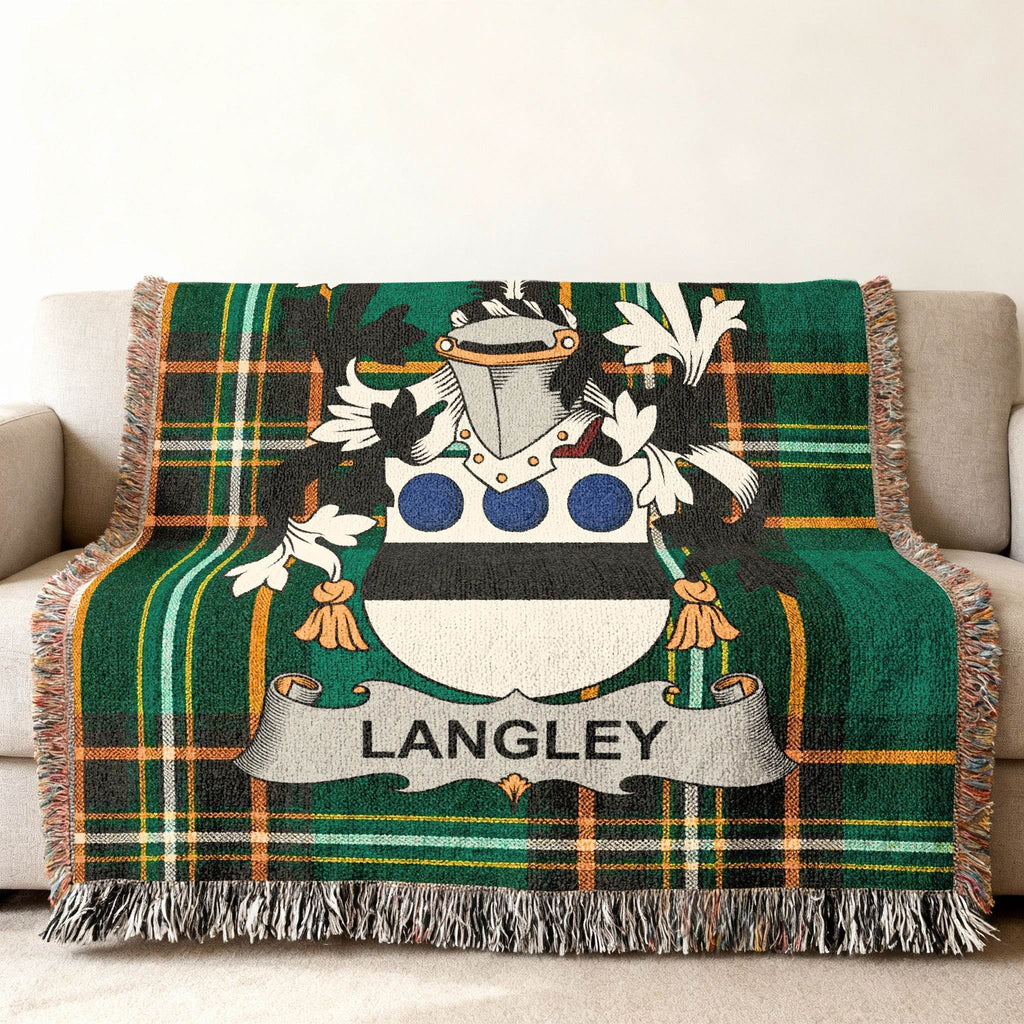 Green plaid throw blanket with Langley family crest centered on it.