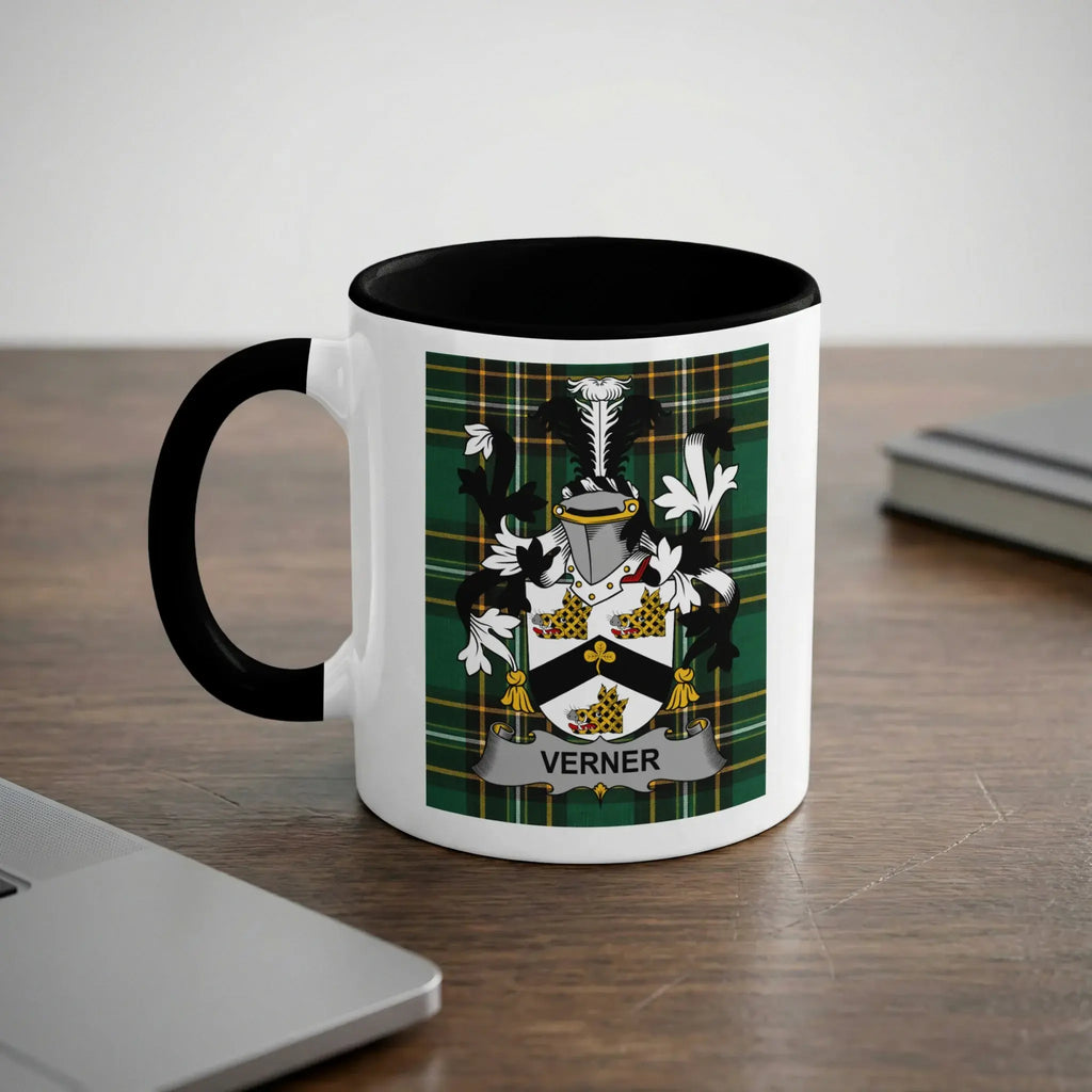White mug with black handle featuring the Verner family crest on a tartan background.