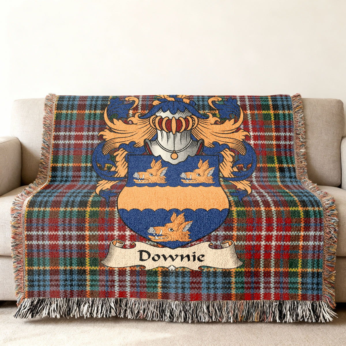 Downie family crest emblem on a Caledonia tartan woven blanket