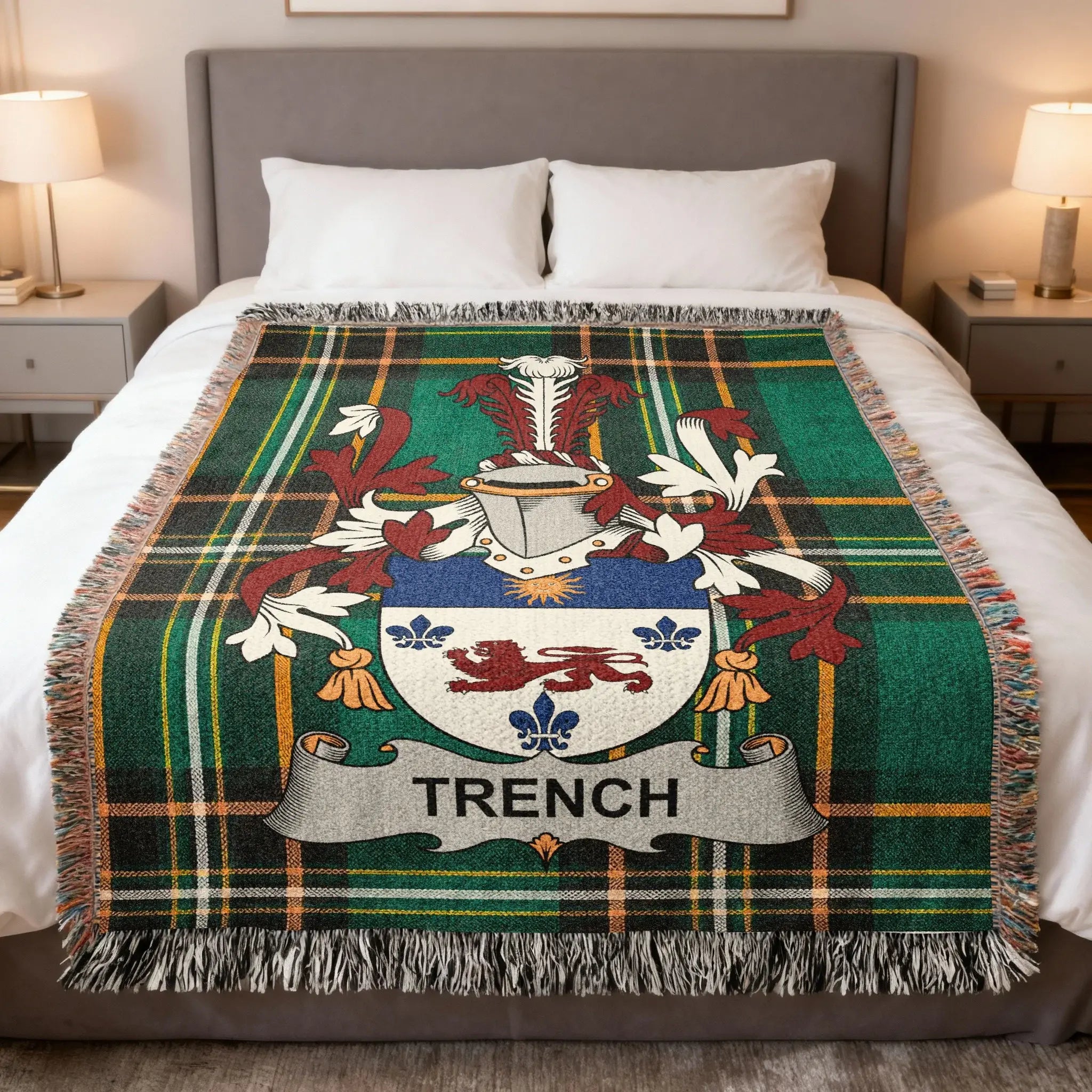 Trench family crest on a green plaid woven throw blanket on a bed.