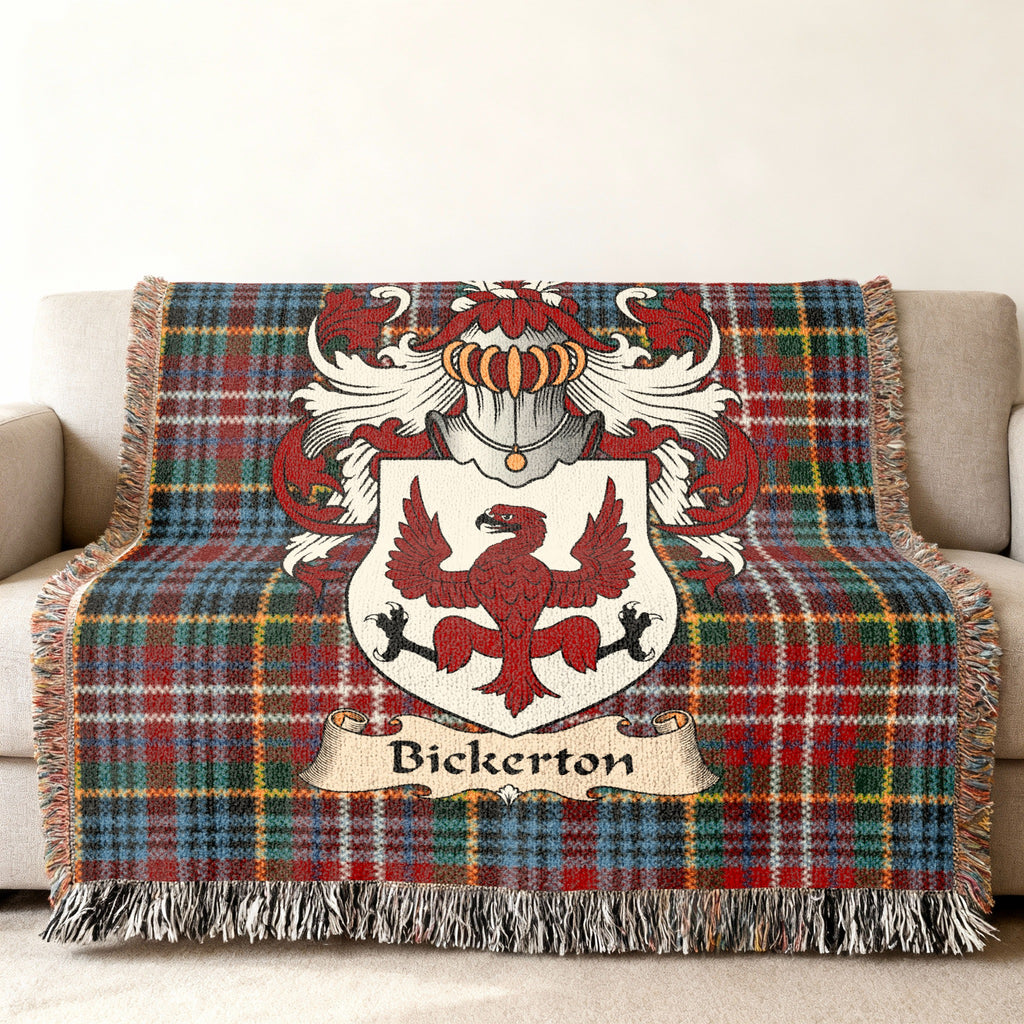 Bickerton Scottish family shield woven blanket with Caledonia tartan background on a sofa