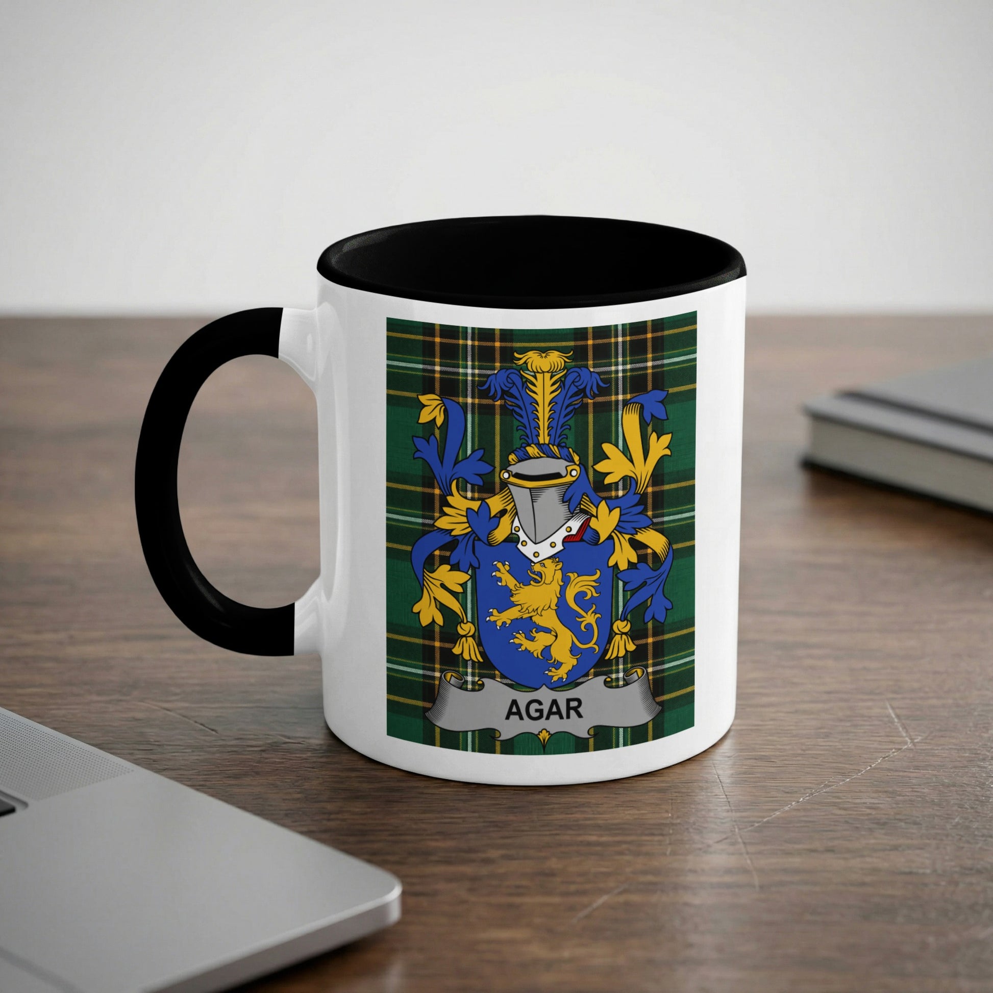 White mug with black interior featuring the Agar family crest on a green tartan background.