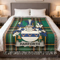Plaid throw blanket with Harforth family crest centered on a bed.