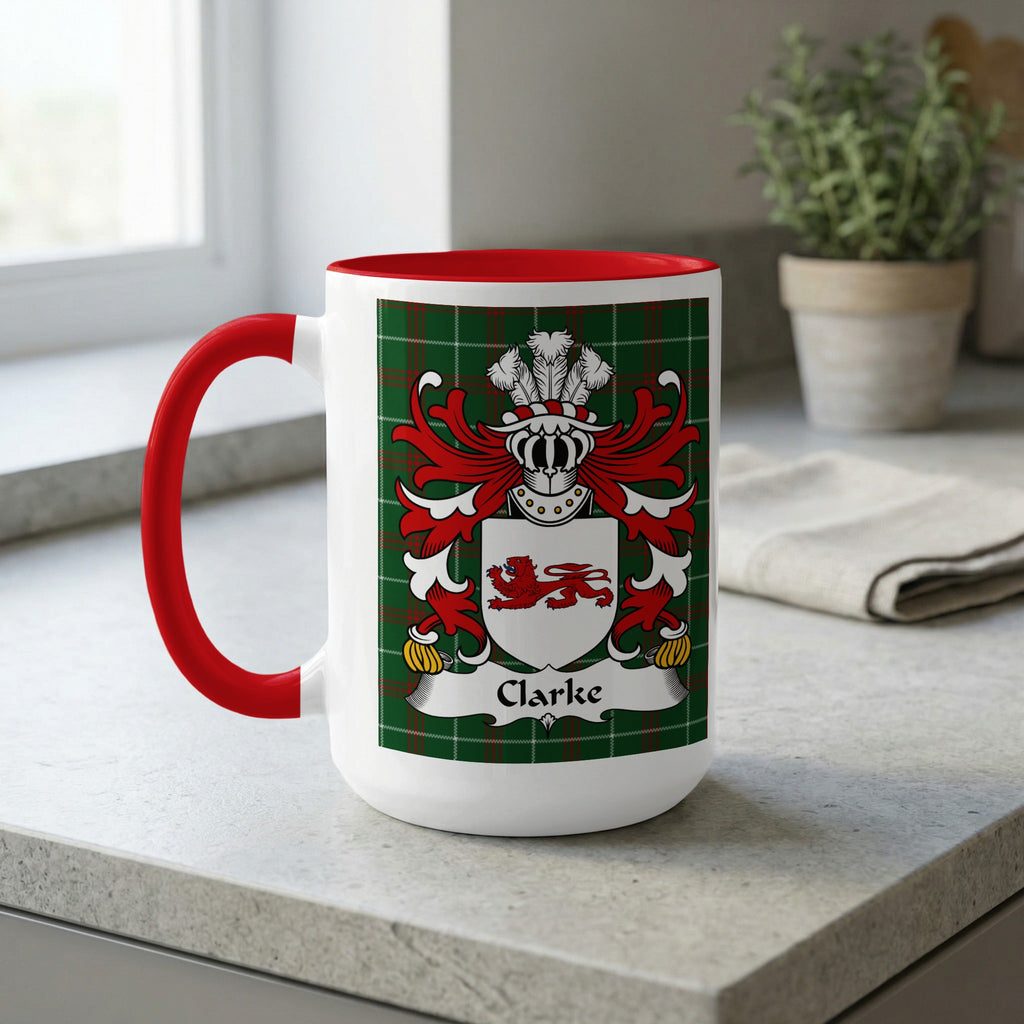 White mug with red handle, featuring the Clarke family crest on a tartan background.
