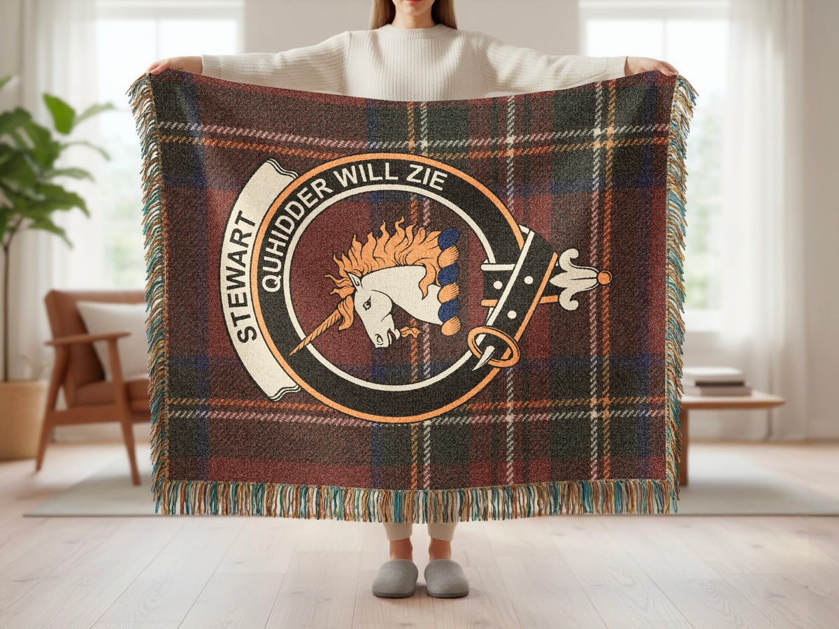 Person holding the Stewart of Appin woven blanket to show the full design, tartan background and fringe