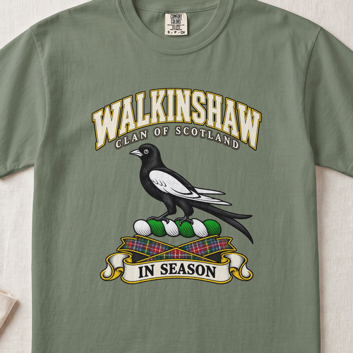 Walkinshaw Scottish clan T-shirt in Moss, front view with a black and white magpie and motto design.