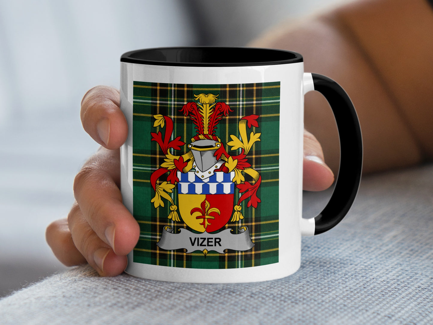 White mug with black handle displaying the Vizer coat of arms on tartan background.