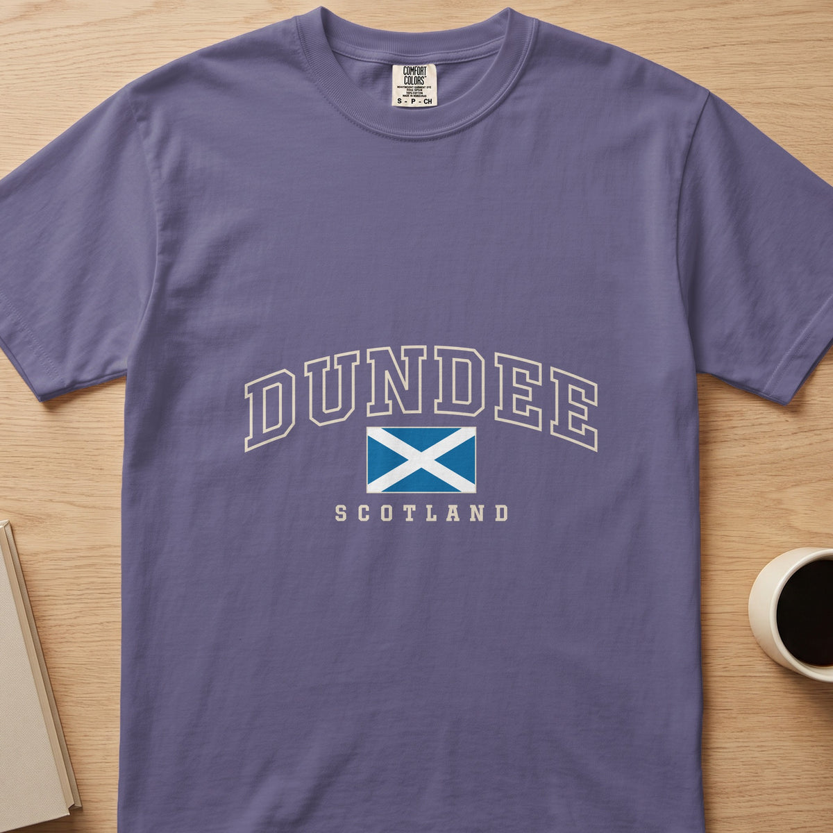 Grape purple Dundee Scotland Comfort Colors T-shirt laid flat with the Saltire and cream lettering