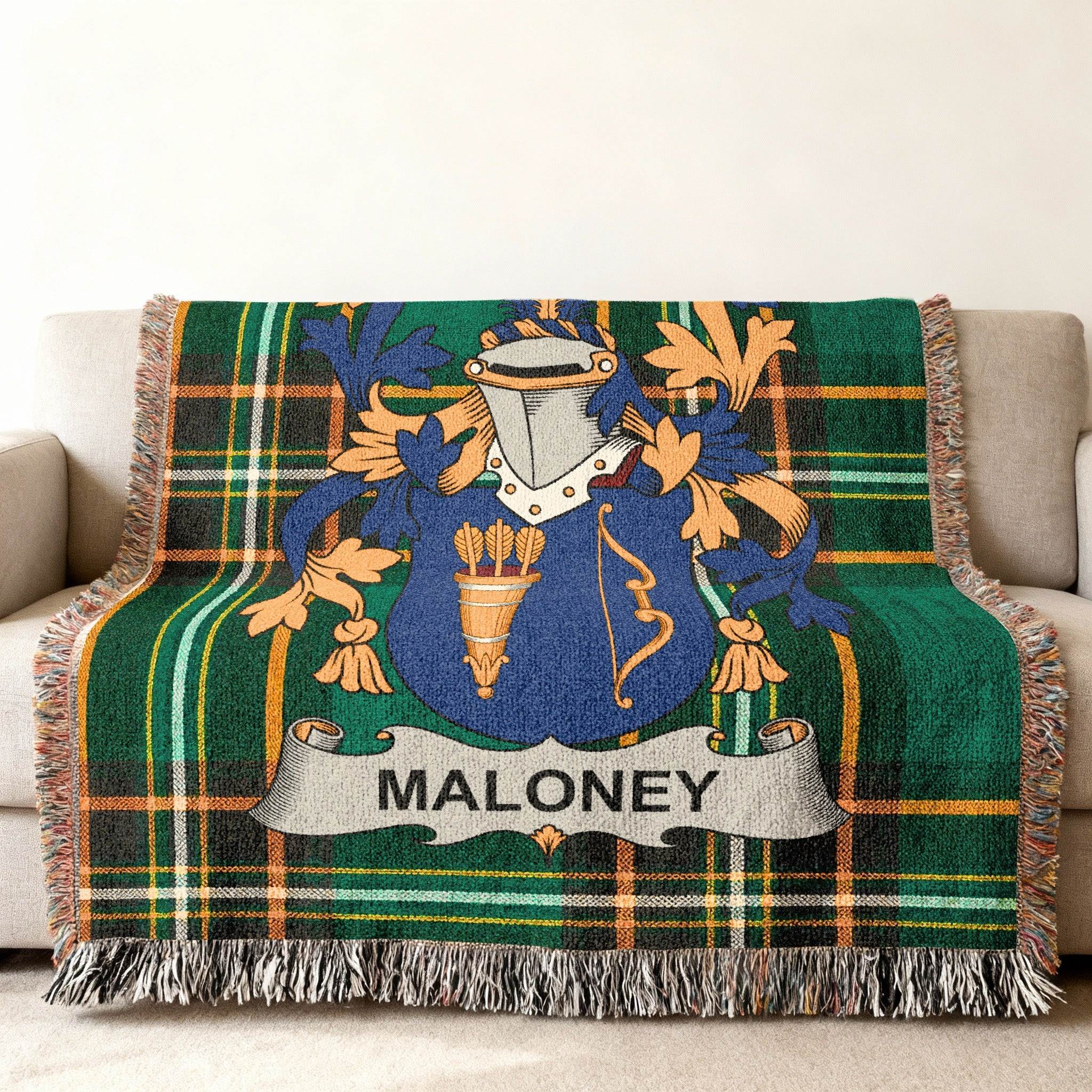 Green tartan throw blanket with Maloney family crest and name banner.