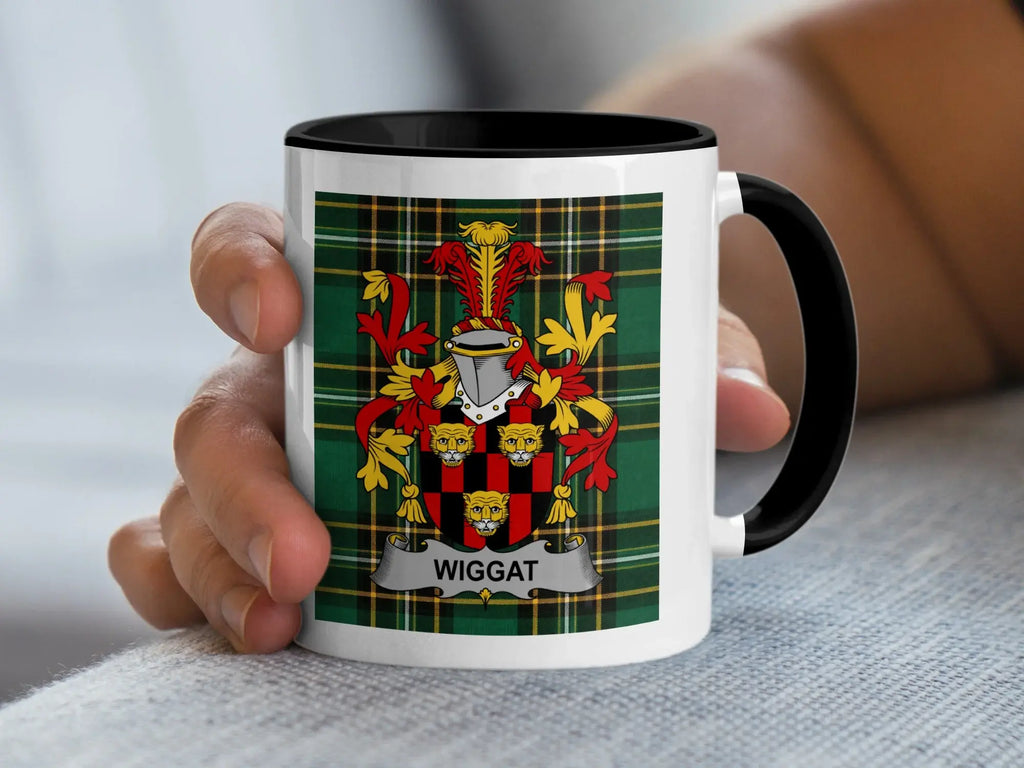 White mug with black rim featuring the Wiggatt family crest on a green tartan background.
