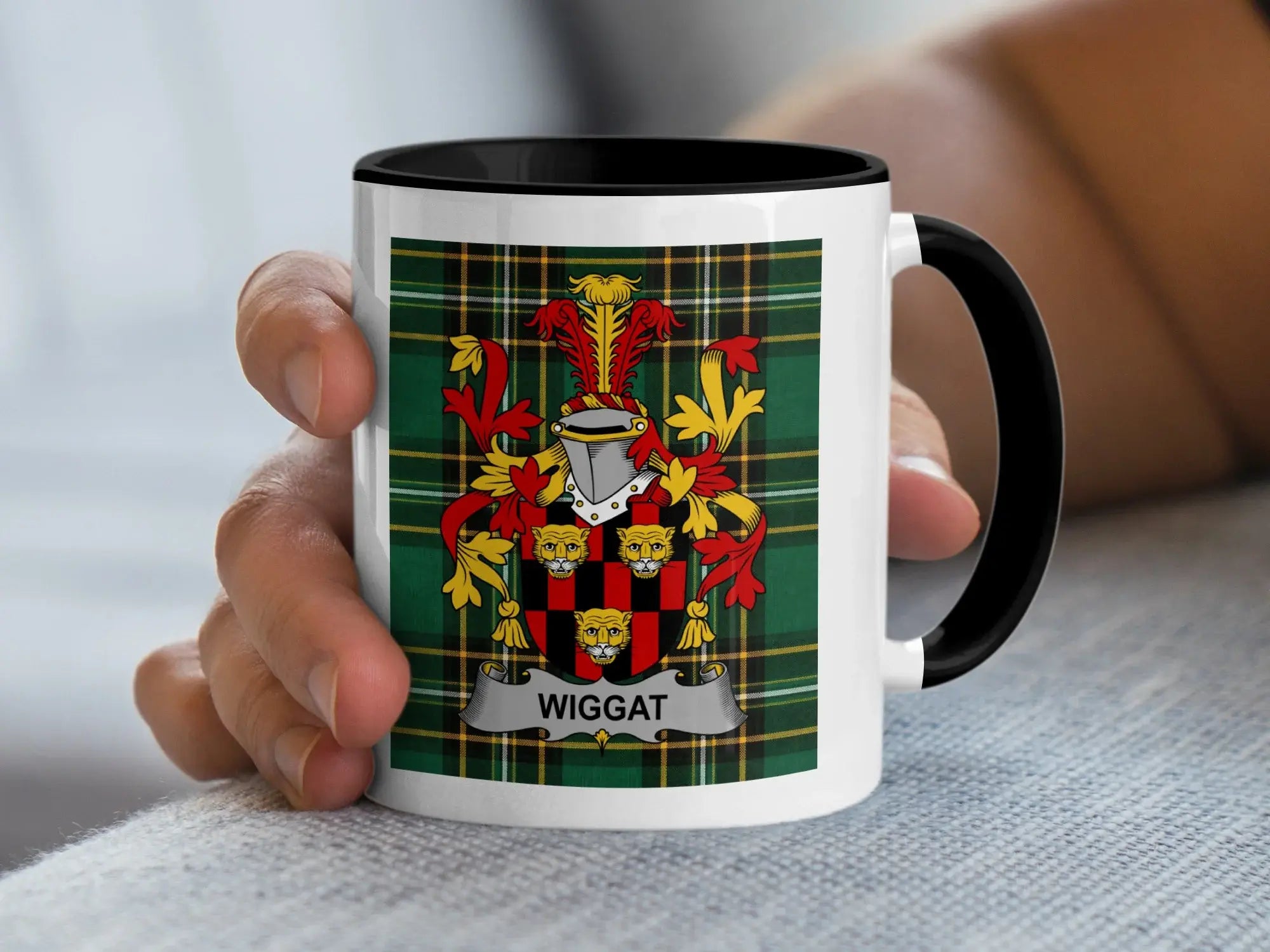 White mug with black rim featuring the Wiggatt family crest on a green tartan background.