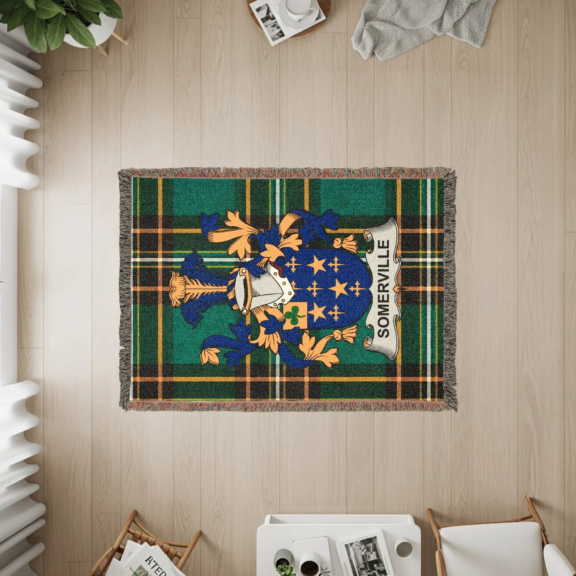 Woven blanket with Somerville crest and tartan pattern.