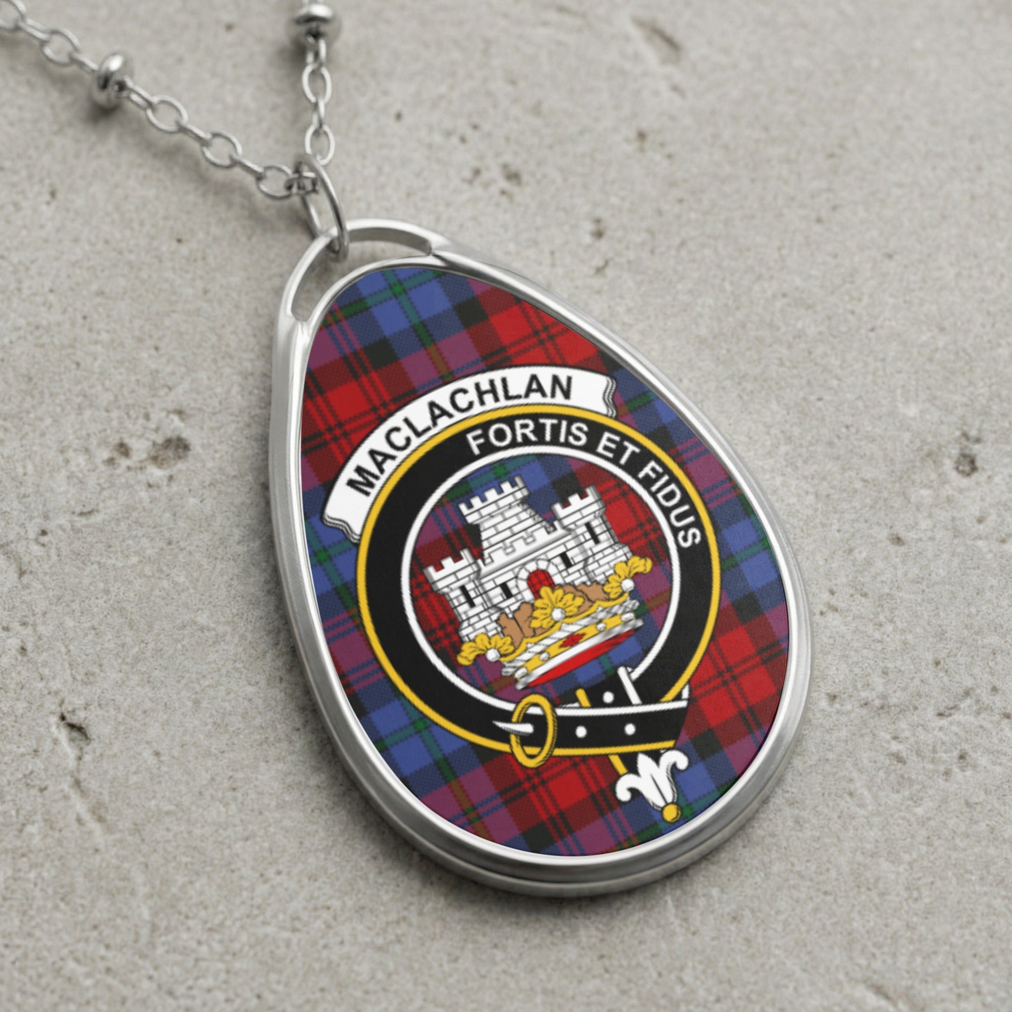 Maclachlan clan crest pendant with silver chain over tartan background.