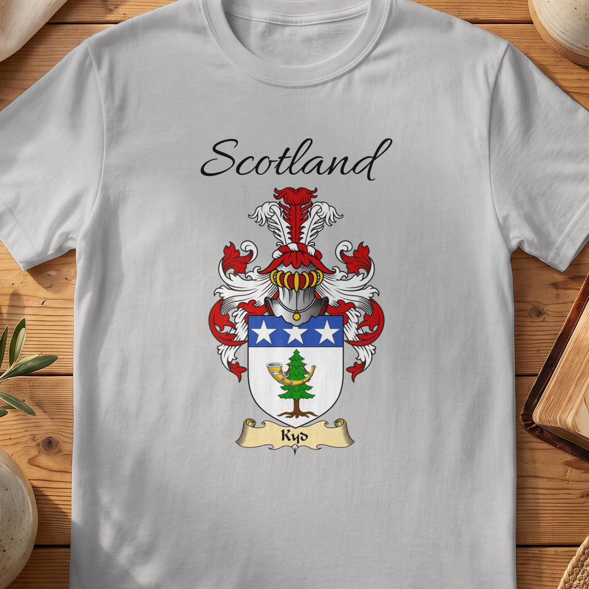 Sport Grey Kyd Scottish family shield T-shirt featuring a blue top band with white stars above a green motif
