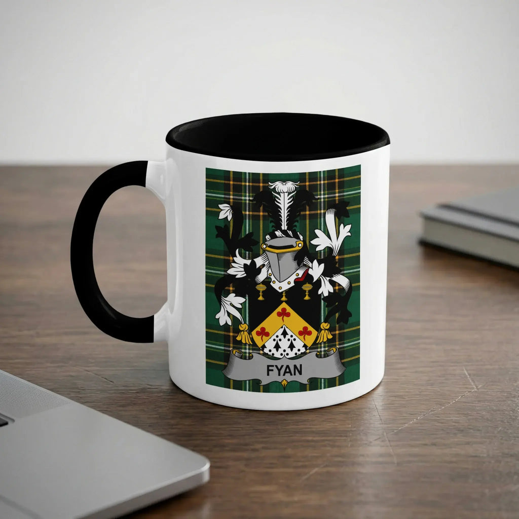 Mug with Fyan family crest on a wooden desk.
