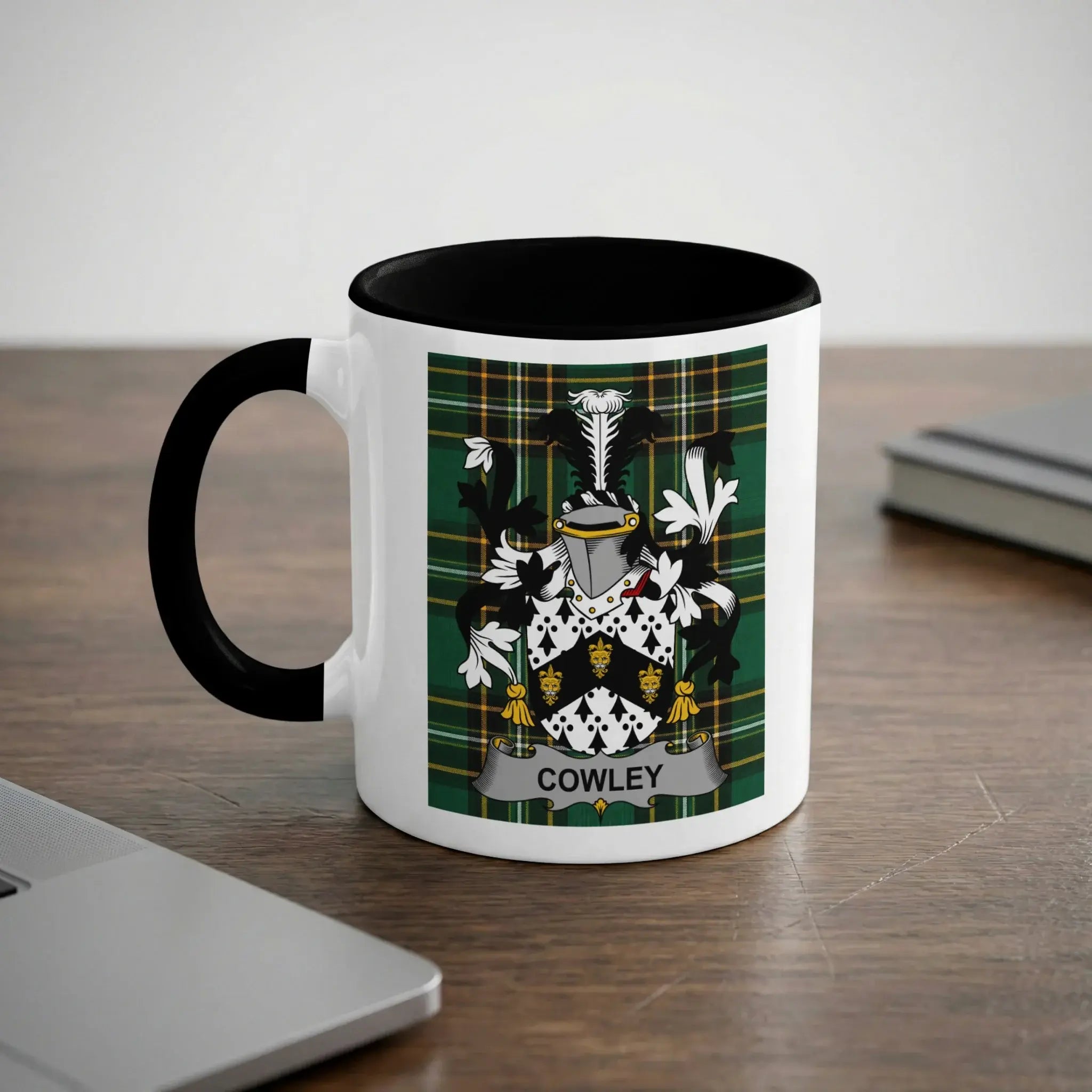 Mug with a black rim and handle, featuring the Cowley coat of arms.