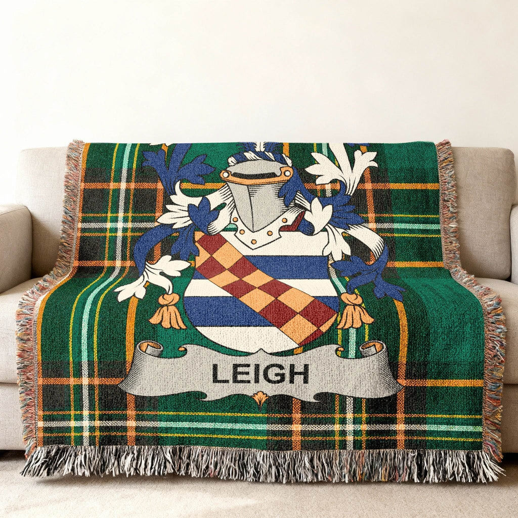Green plaid throw blanket featuring the Leigh family crest with a shield and banner.