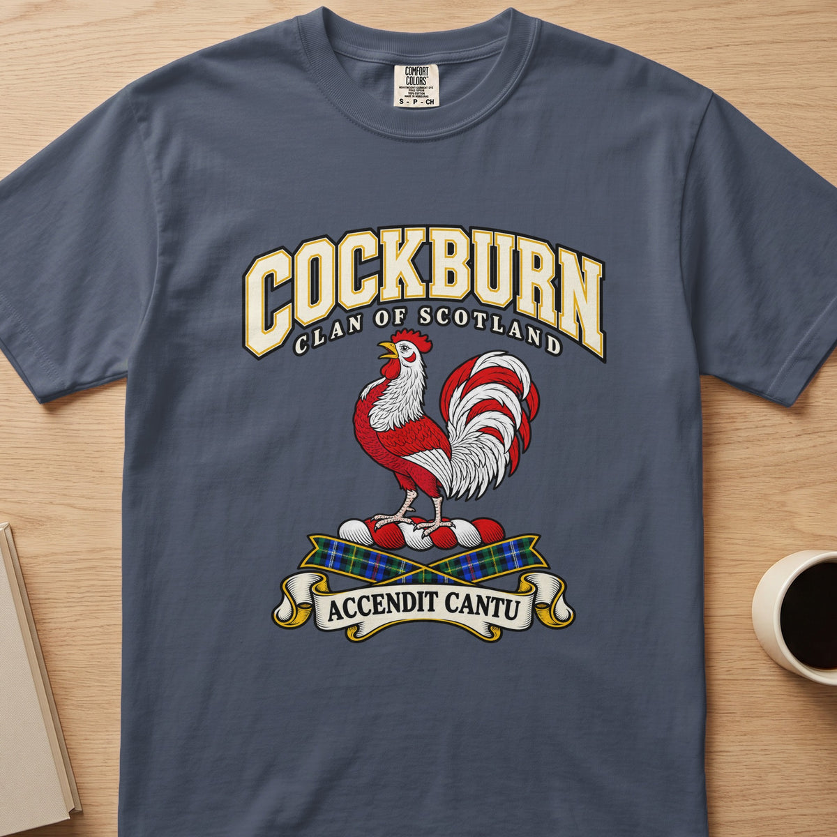 Cockburn red-and-white rooster crest graphic on a slate blue Comfort Colors T-shirt, front view