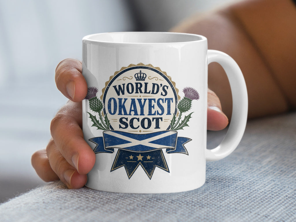 Mug with "World's Okayest Scot" text and Scottish thistle and flag.