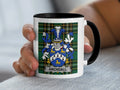White mug with black rim featuring the Archdall coat of arms on a tartan background.