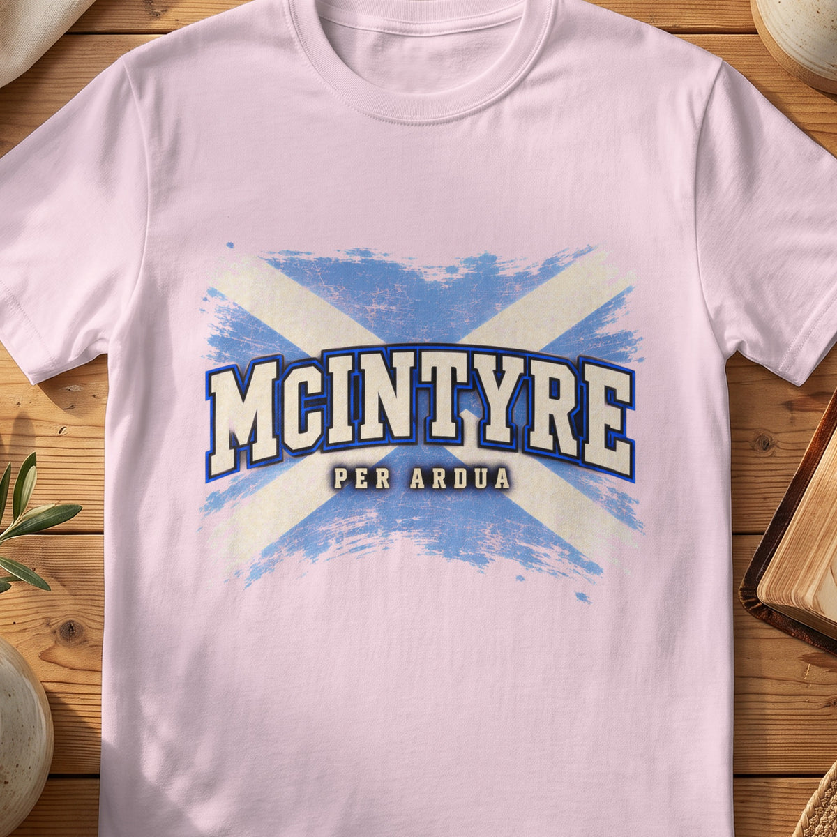 McIntyre Scottish Saltire T-shirt in Light Pink, with distressed blue and cream flag and “Per Ardua” lettering.