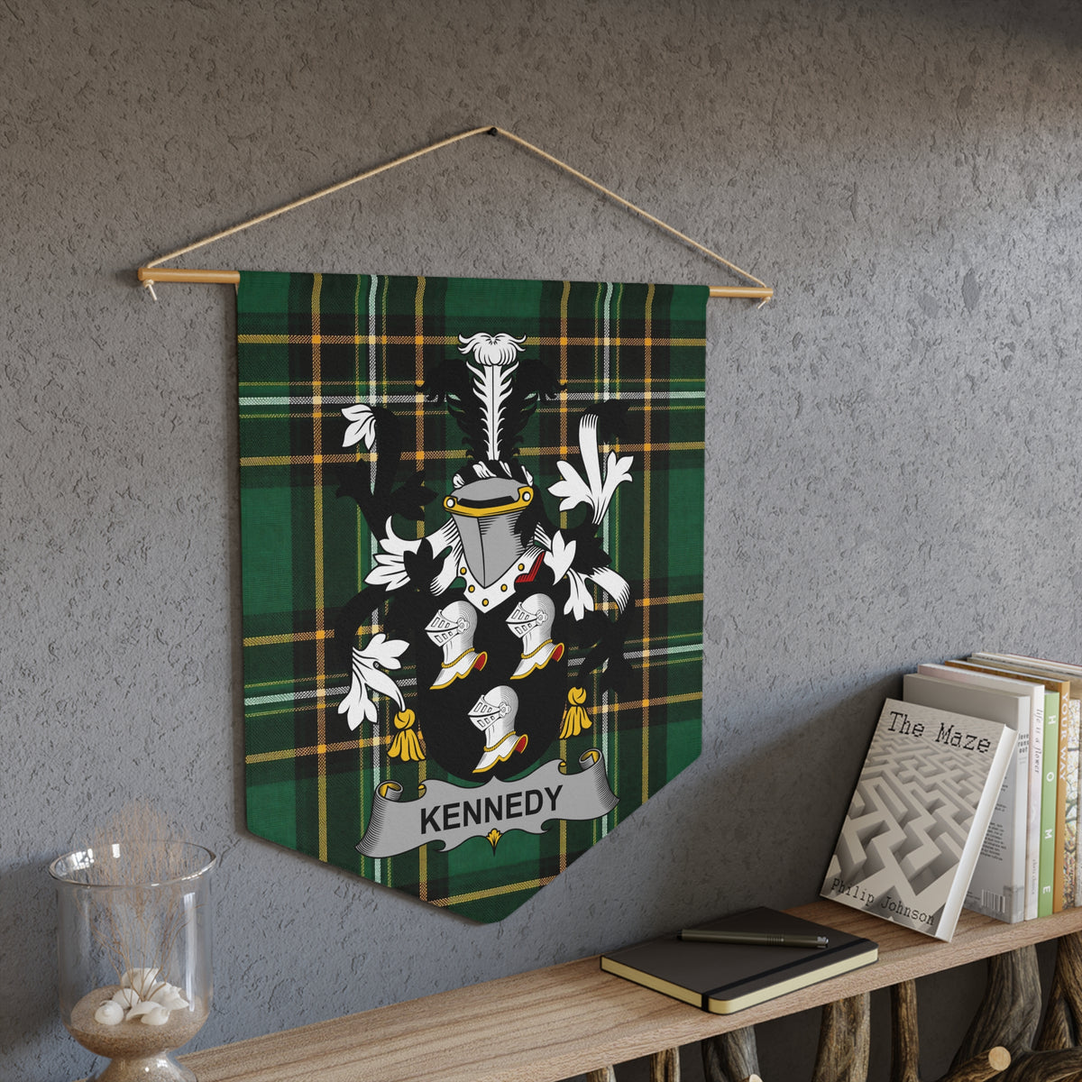 Kennedy family crest on a green tartan pennant hanging on a wall.