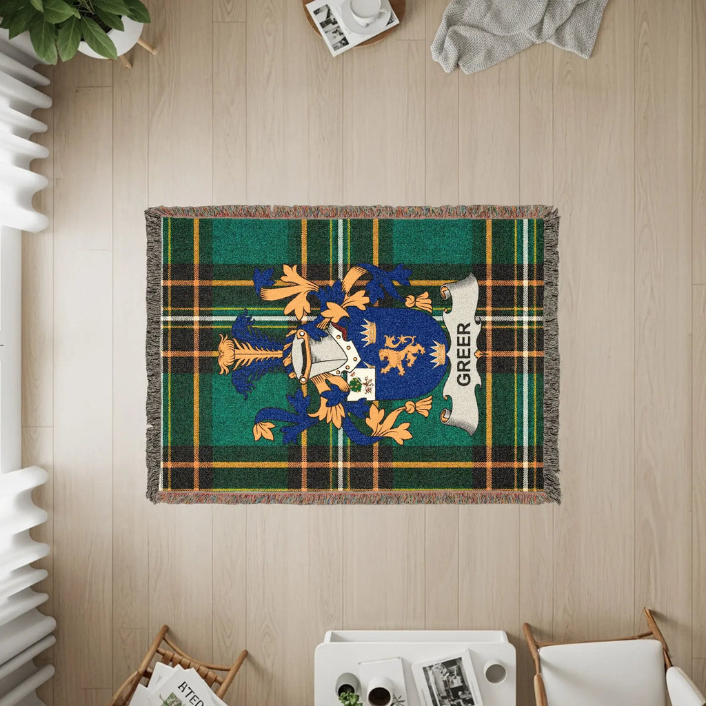 Green plaid blanket with Greer family crest and fringe.