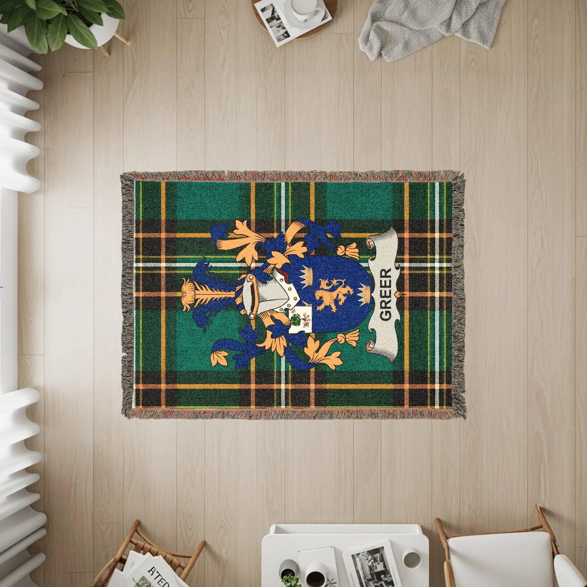 Green plaid blanket with Greer family crest and fringe.