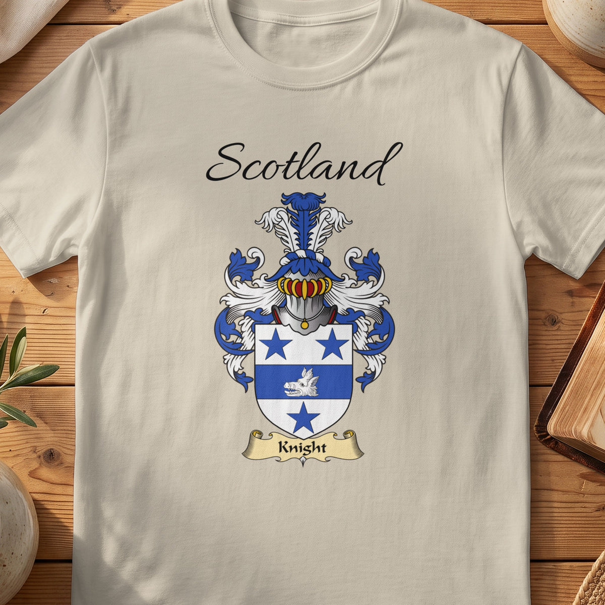 Sand Knight Scottish family shield T-shirt featuring blue stars and a white ship motif