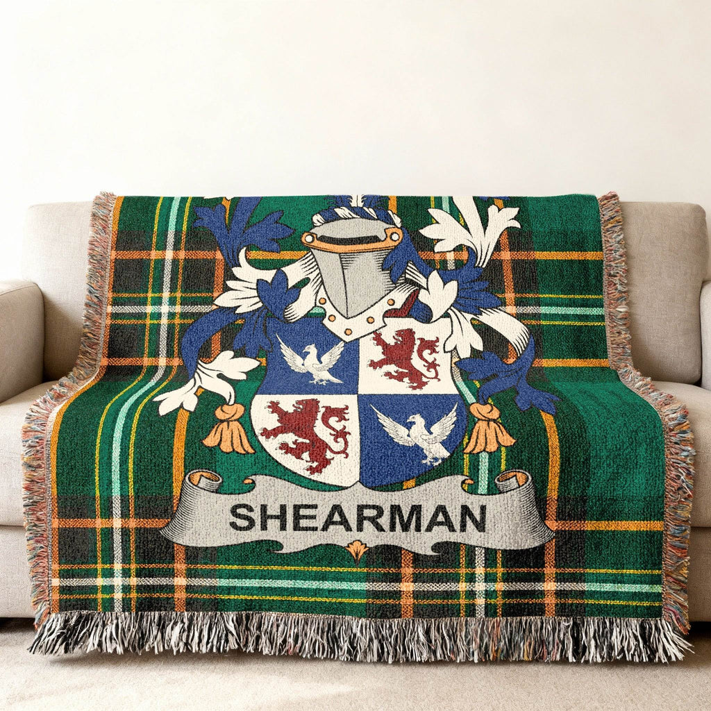 Sherman family crest on a green tartan plaid throw blanket.