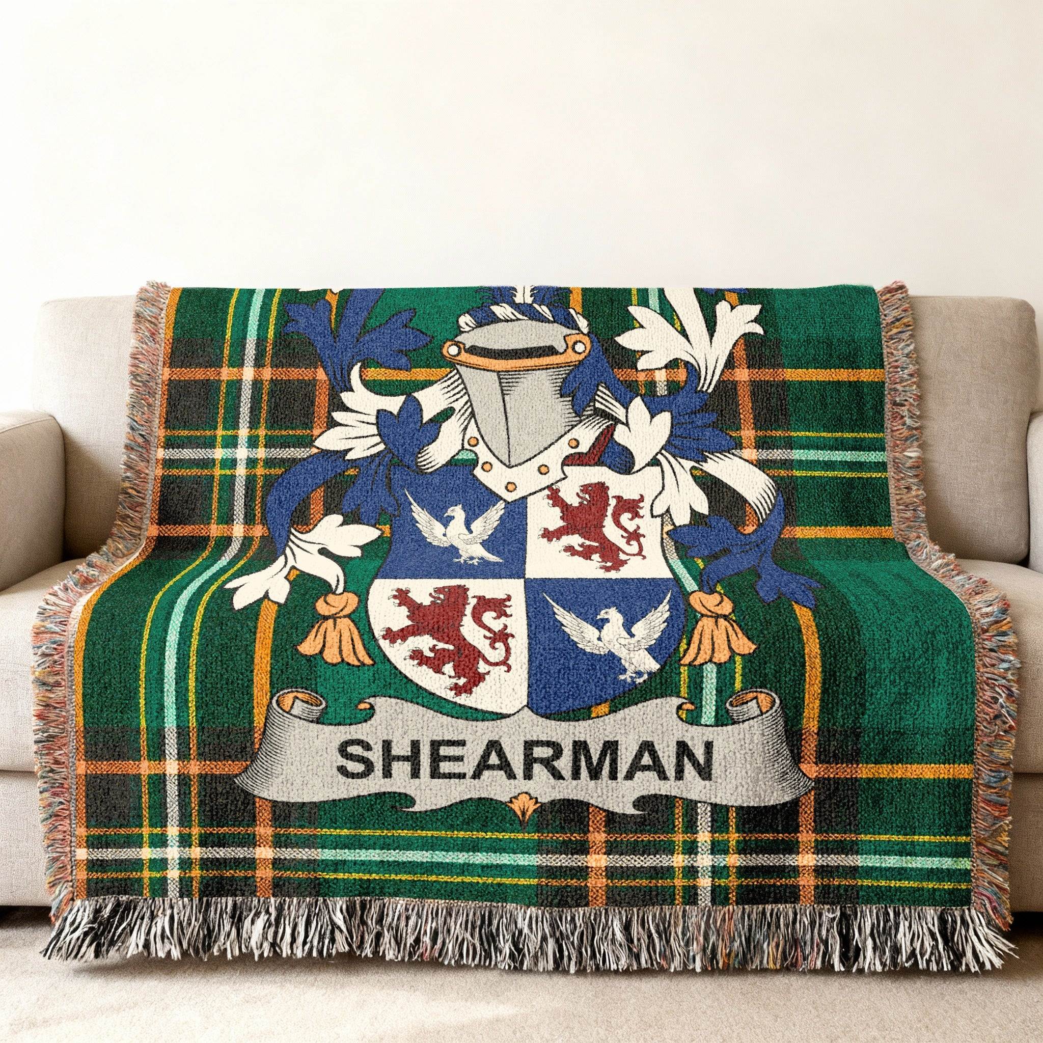 Sherman family crest on a green tartan plaid throw blanket.