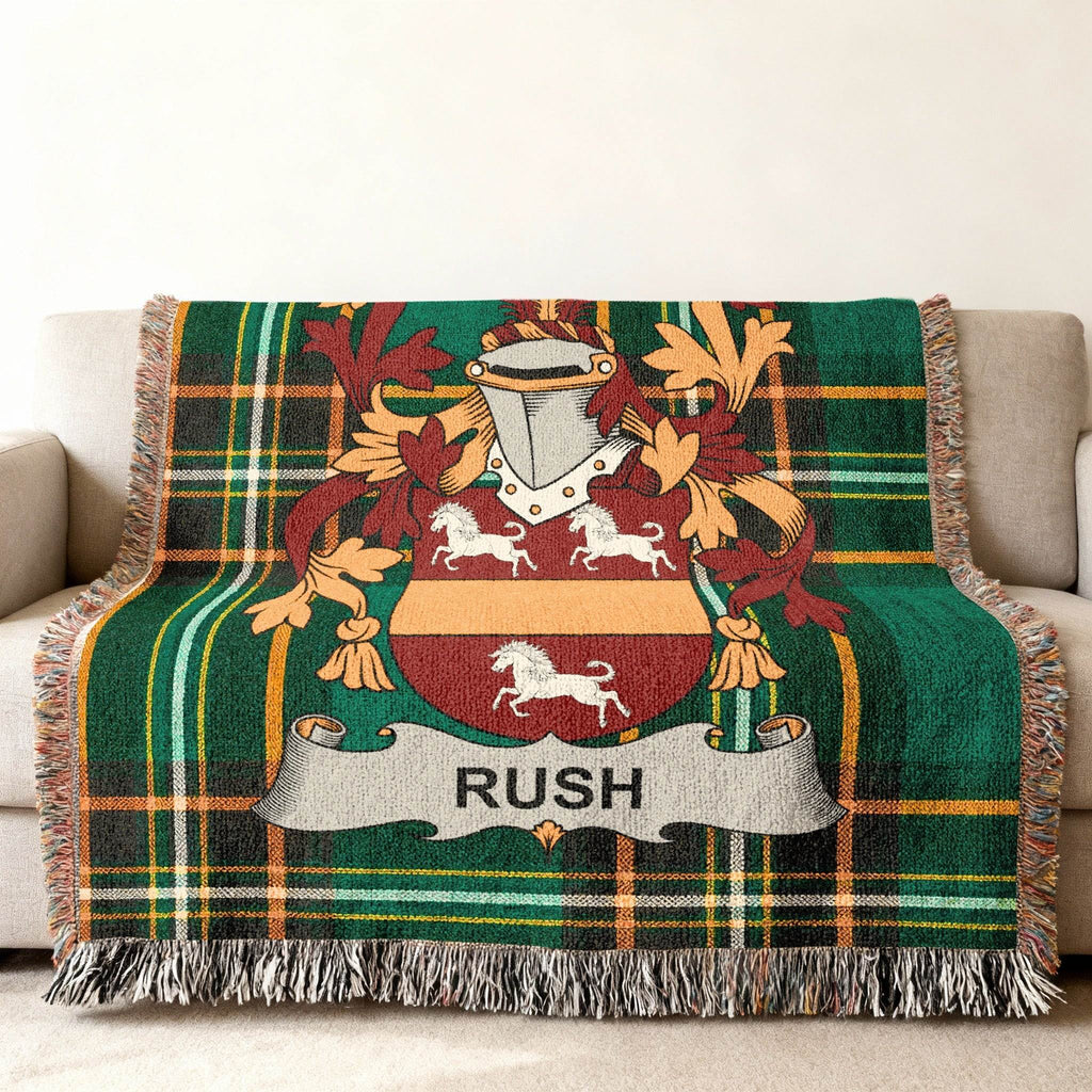 Green plaid throw blanket with Rush family crest and horses.