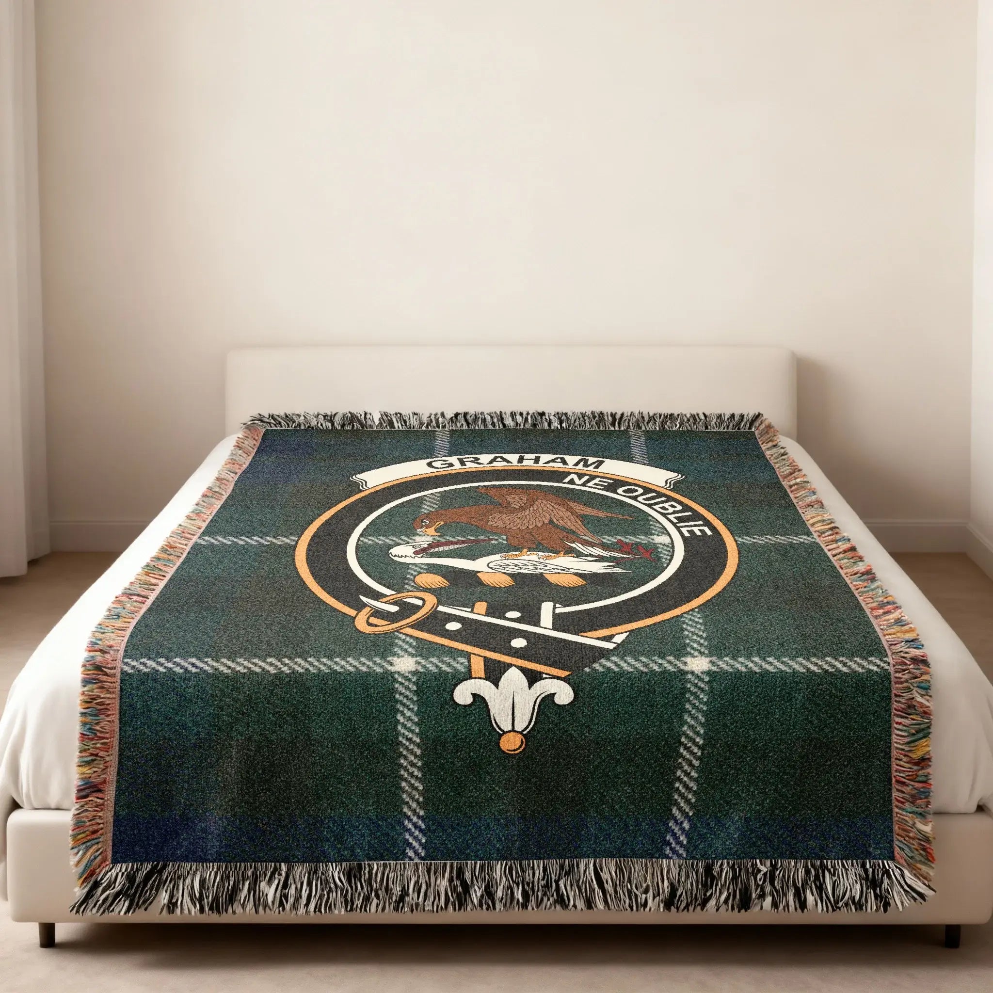 Graham clan Ne Oublie woven blanket folded — showing fringe detail and tartan crest pattern