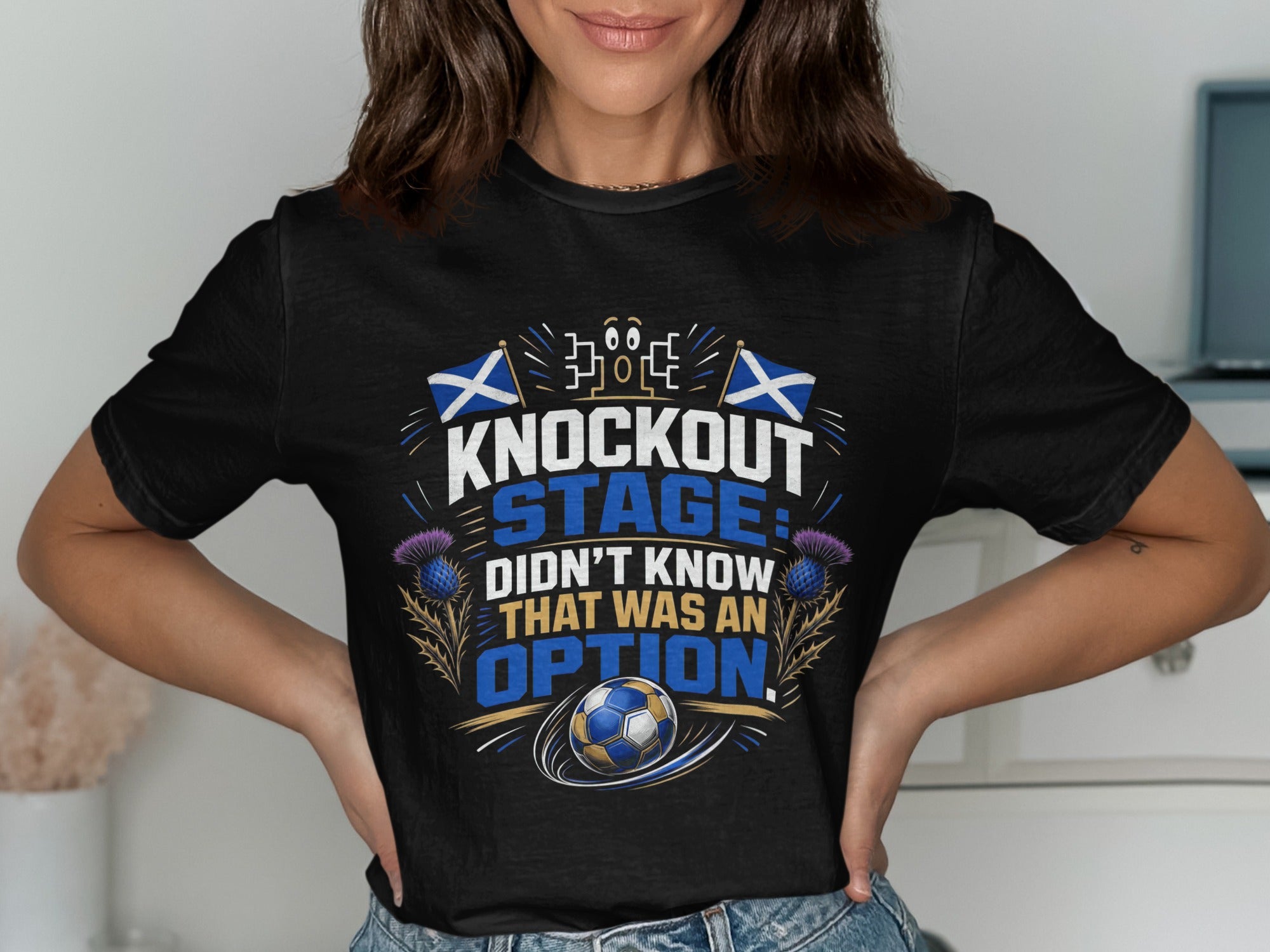 Black t-shirt with "Knockout Stage Didn't Know That Was An Option" text, Scottish flags, and soccer ball.