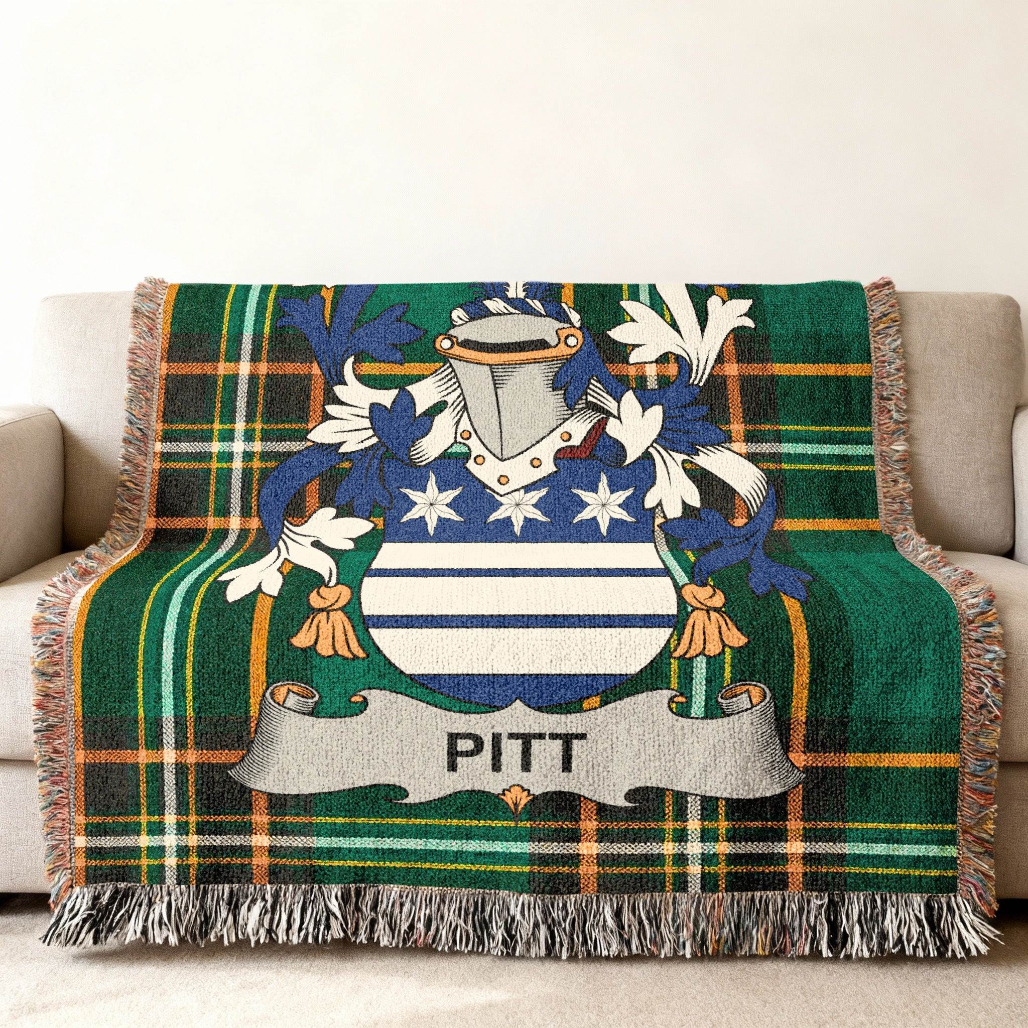Plaid throw blanket featuring the Pitt family crest with gold fringe.