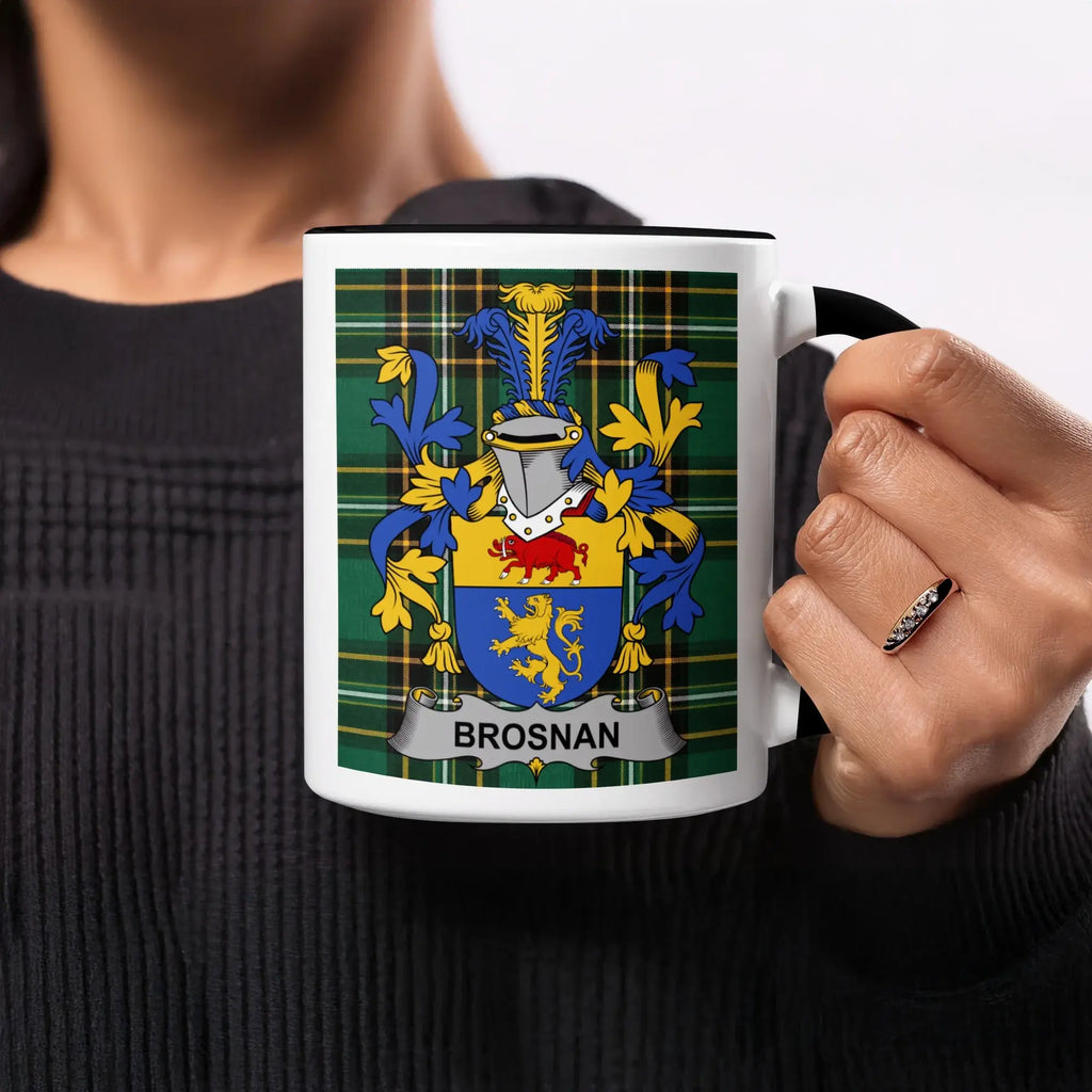 Black and white mug with Brosnan family crest on green plaid background.