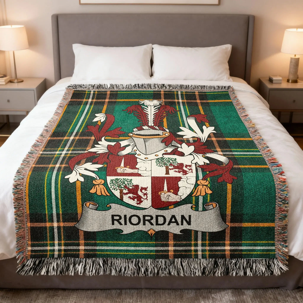 Tartan blanket with Riordan coat of arms on a bed.