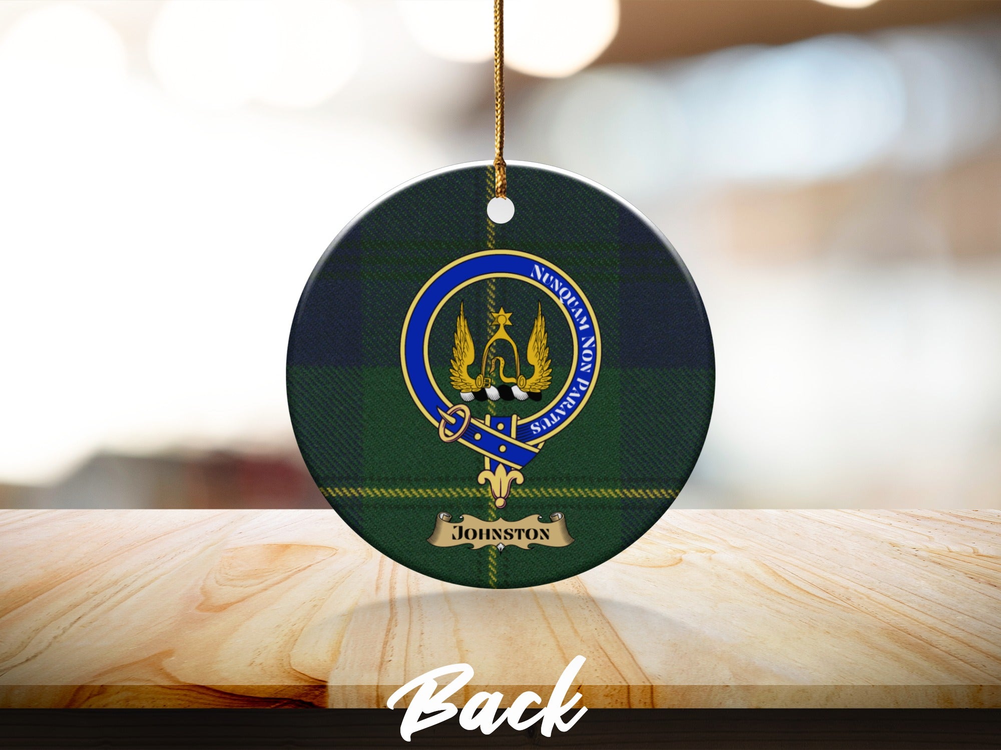 Johnston crest with Nunquam Non Paratus motto on round tartan ornament
