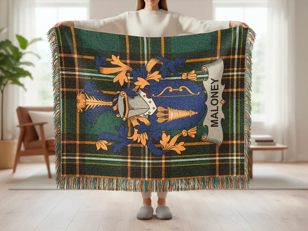 Tartan blanket with Maloney family crest and fringe.