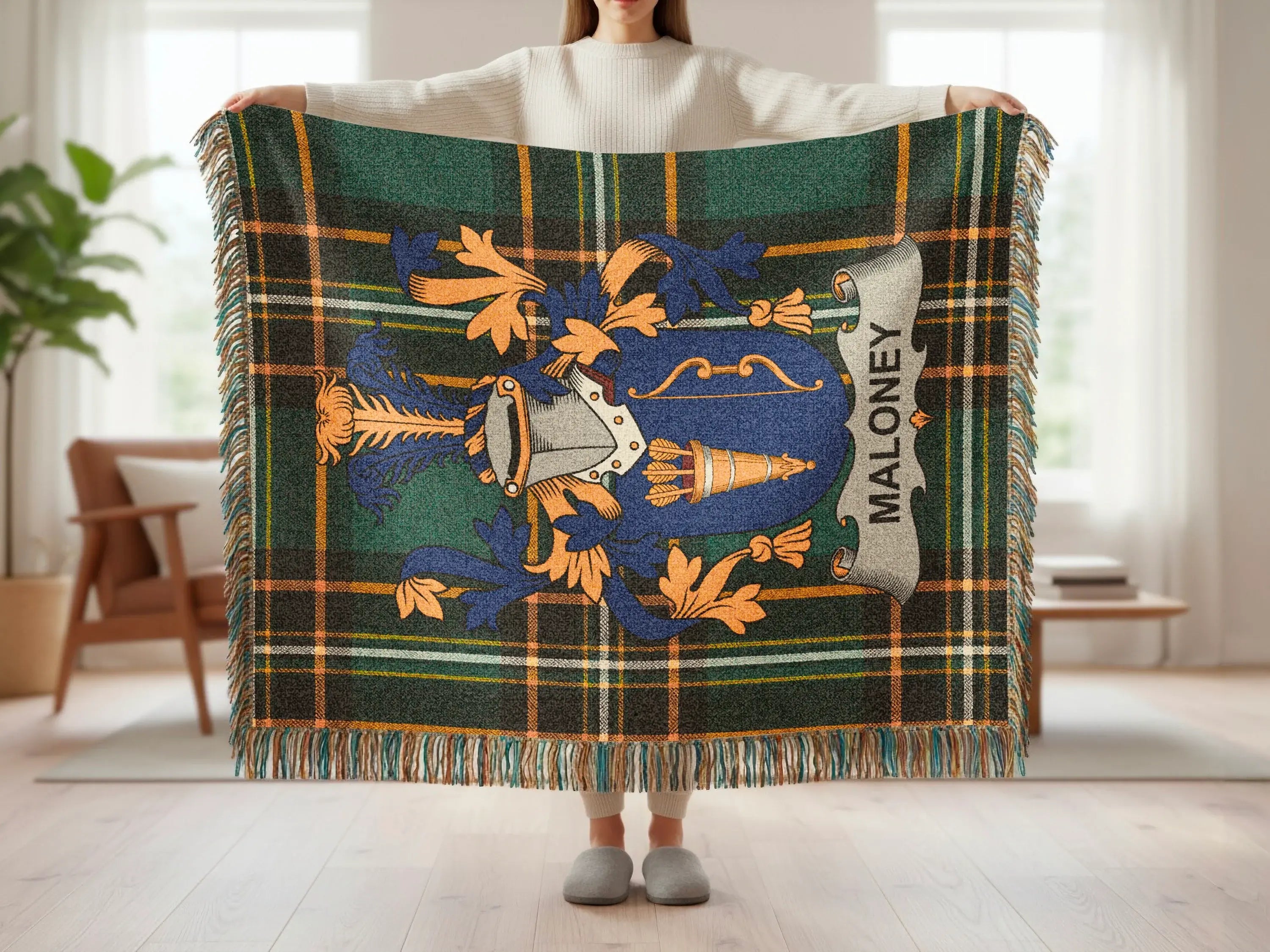 Tartan blanket with Maloney family crest and fringe.