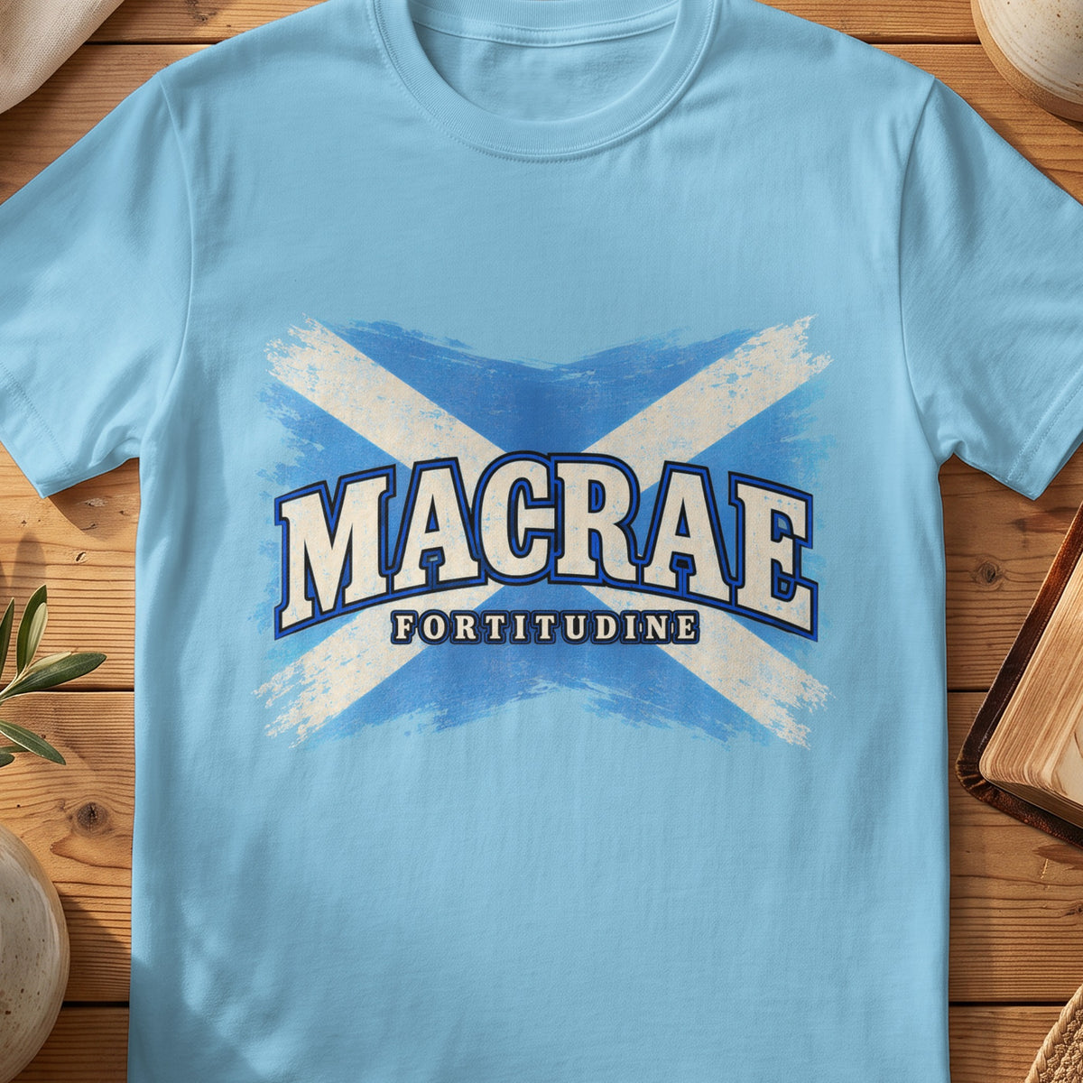 MacRae Scottish Saltire T-shirt in Sky, with distressed blue and cream flag and “Fortitudine” lettering.