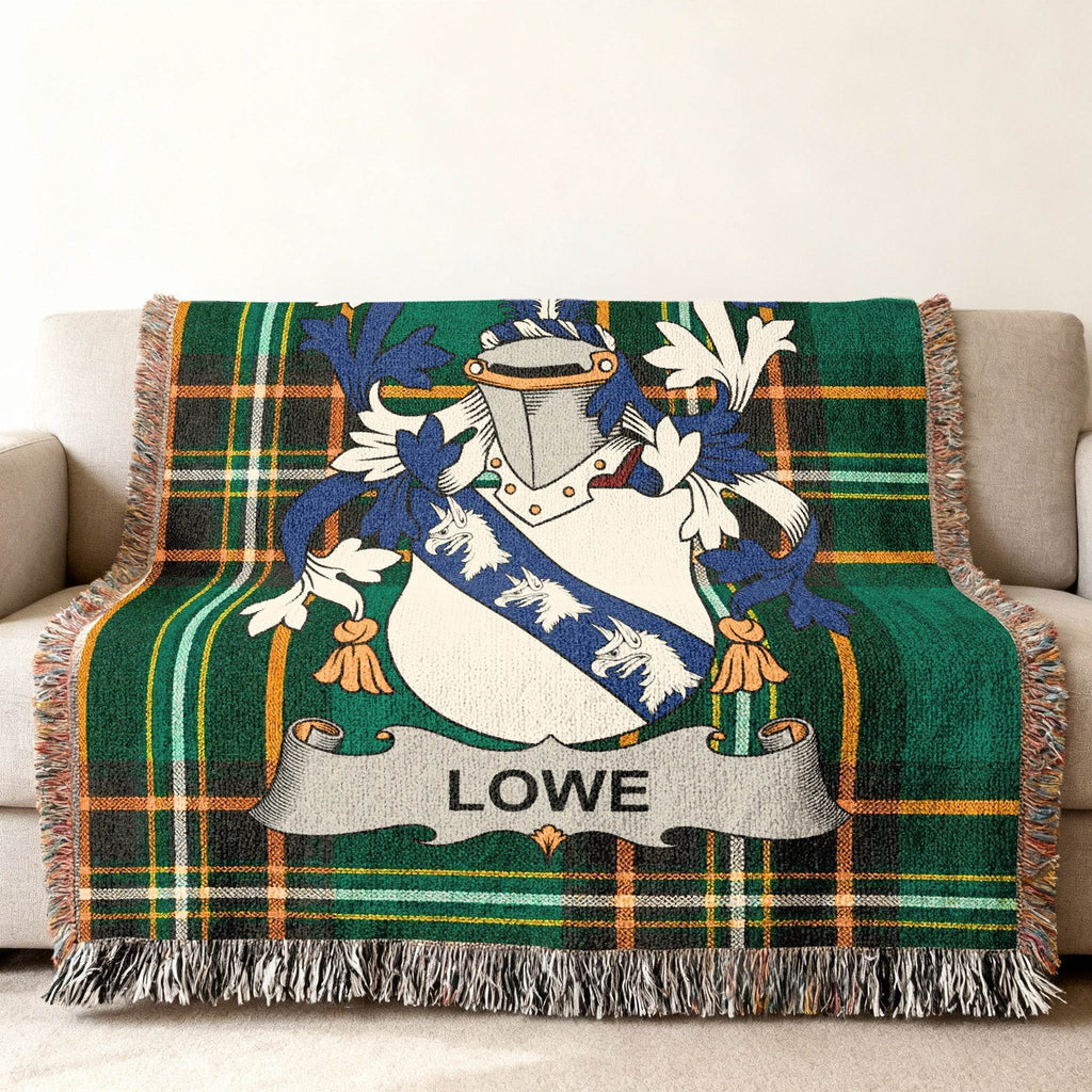 Green plaid throw blanket featuring a family crest with the name Lowe.