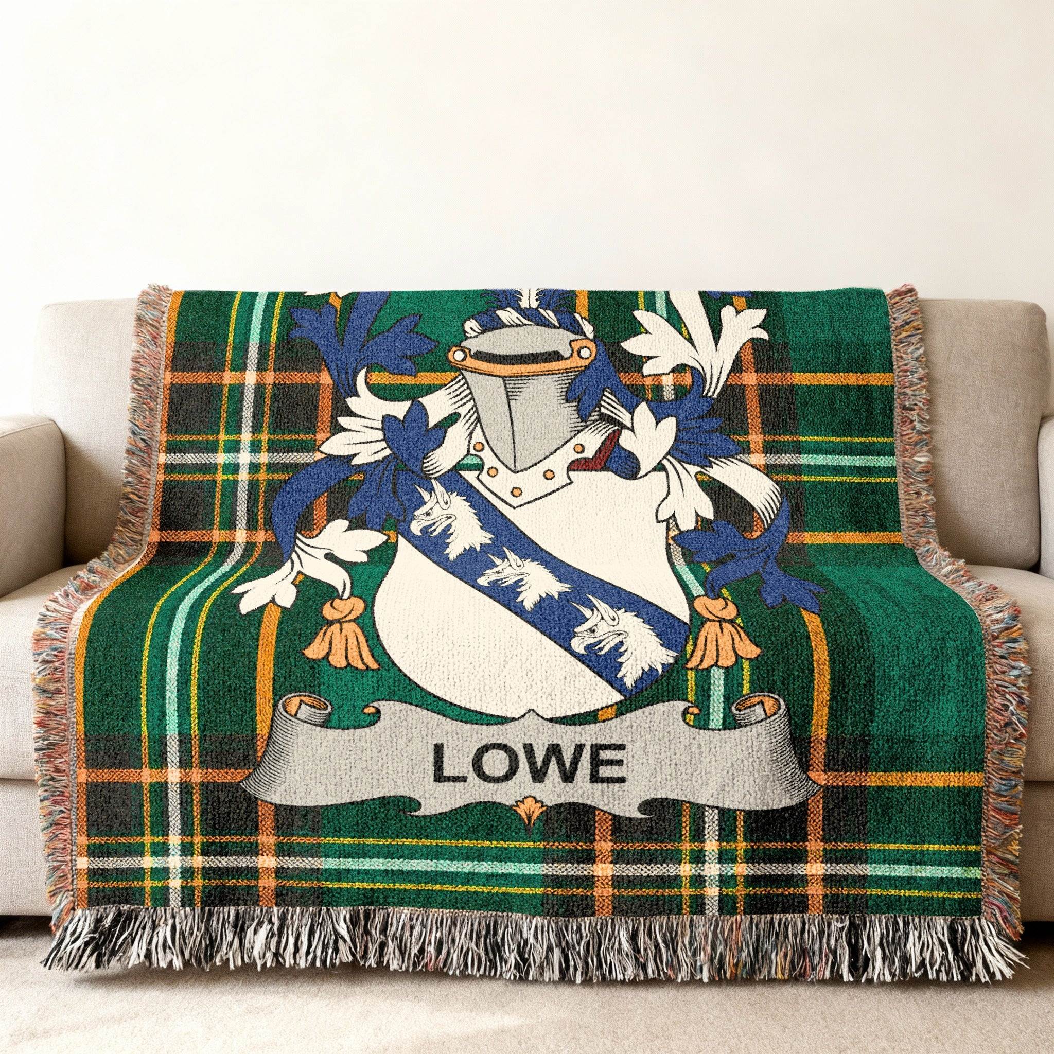 Green plaid throw blanket featuring a family crest with the name Lowe.