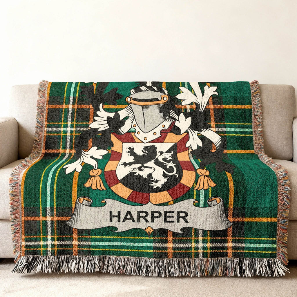 Woven blanket with green plaid pattern and the HARPER family crest.