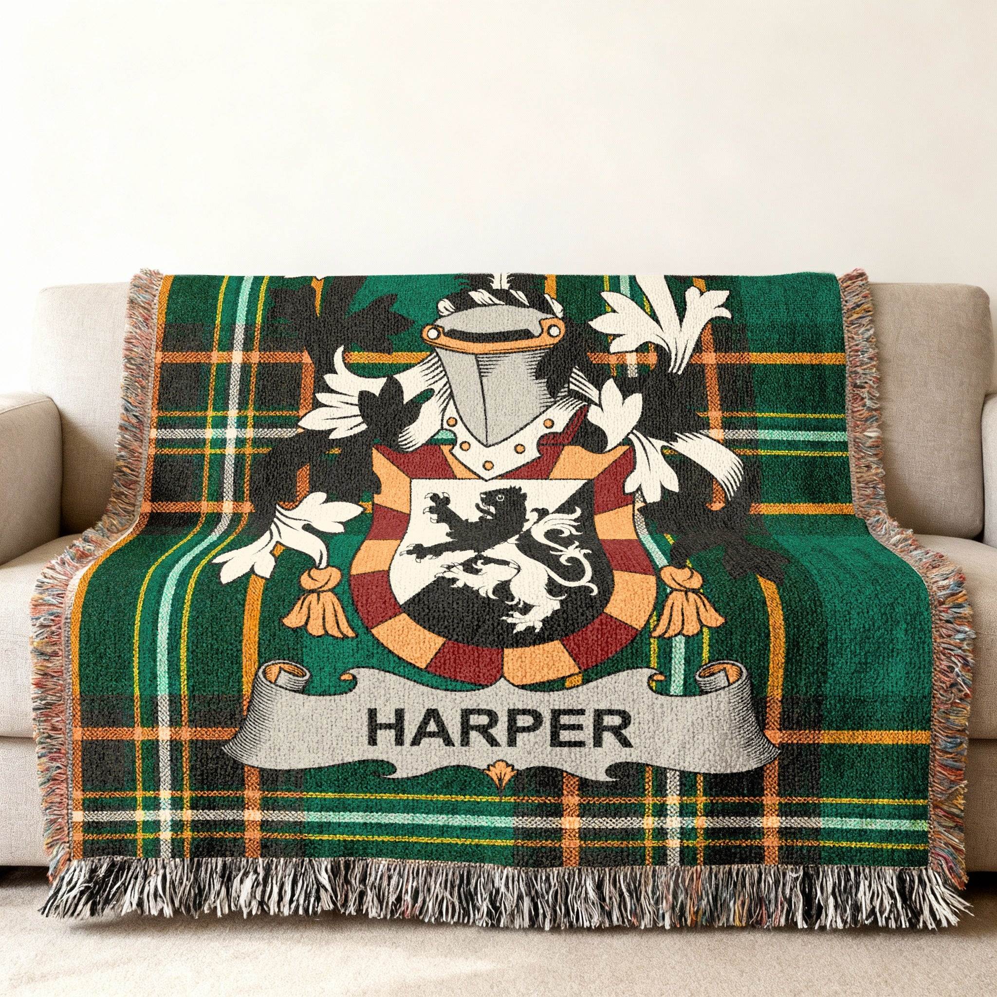 Woven blanket with green plaid pattern and the HARPER family crest.