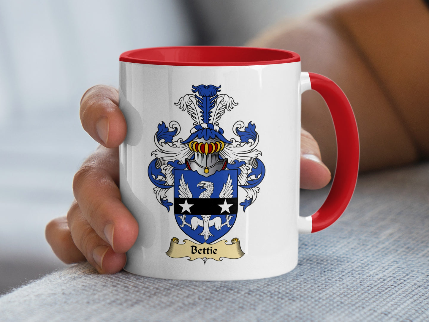 White mug with red handle displaying a coat of arms with the name Bettie.